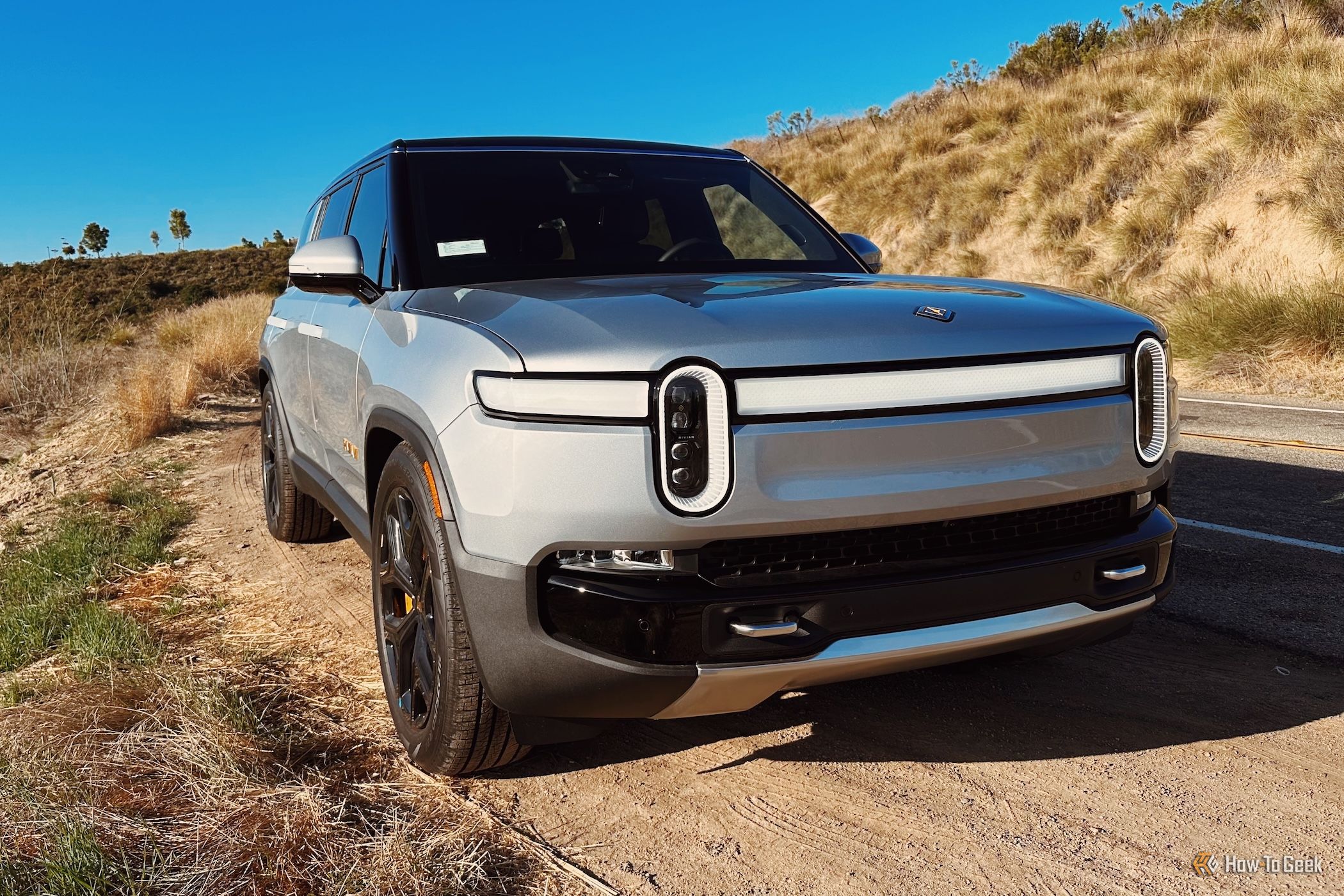 the front of the Rivian R1S parked on the side of the road