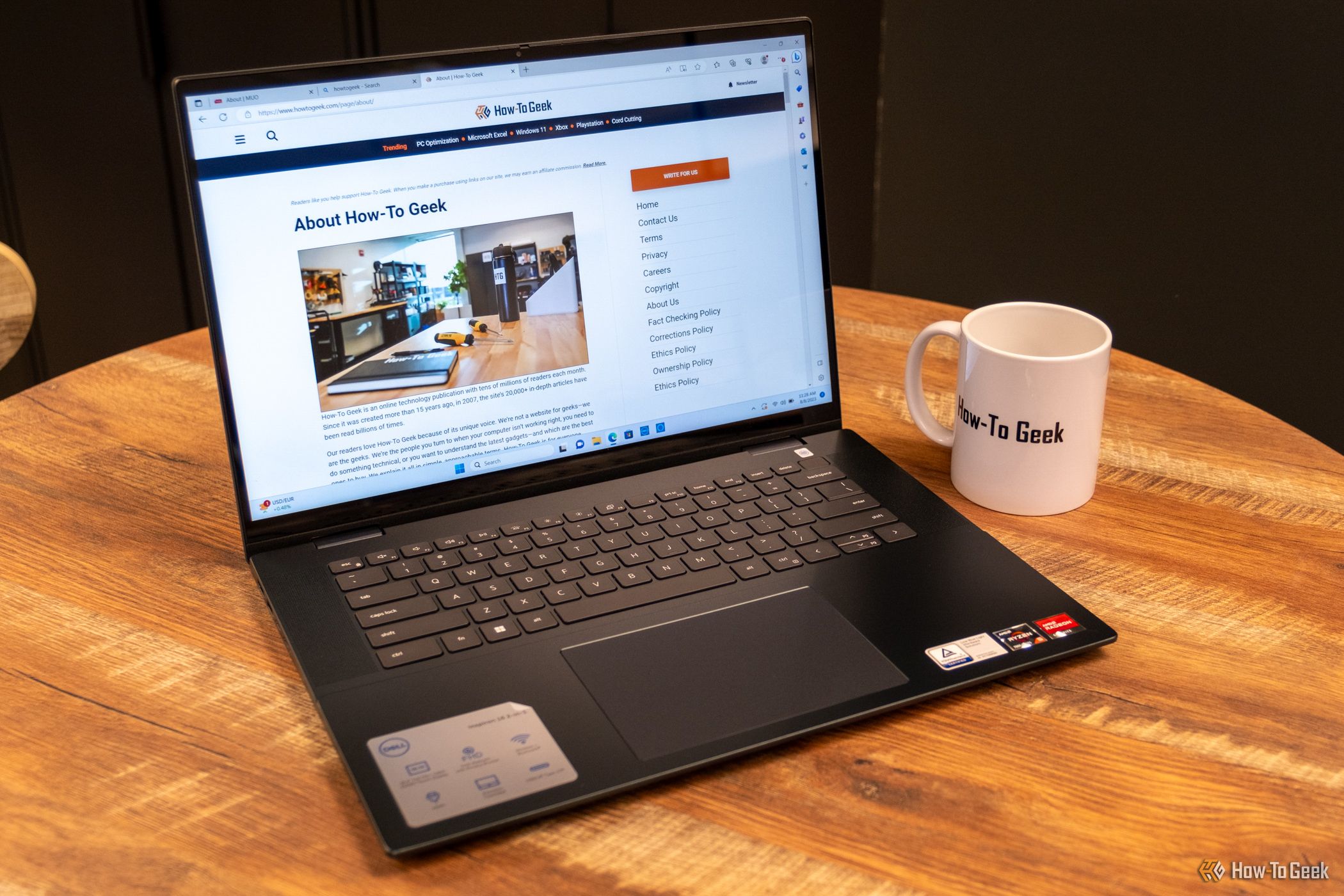 Dell Inspiron 16 2-in-1 being showing on a coffee table