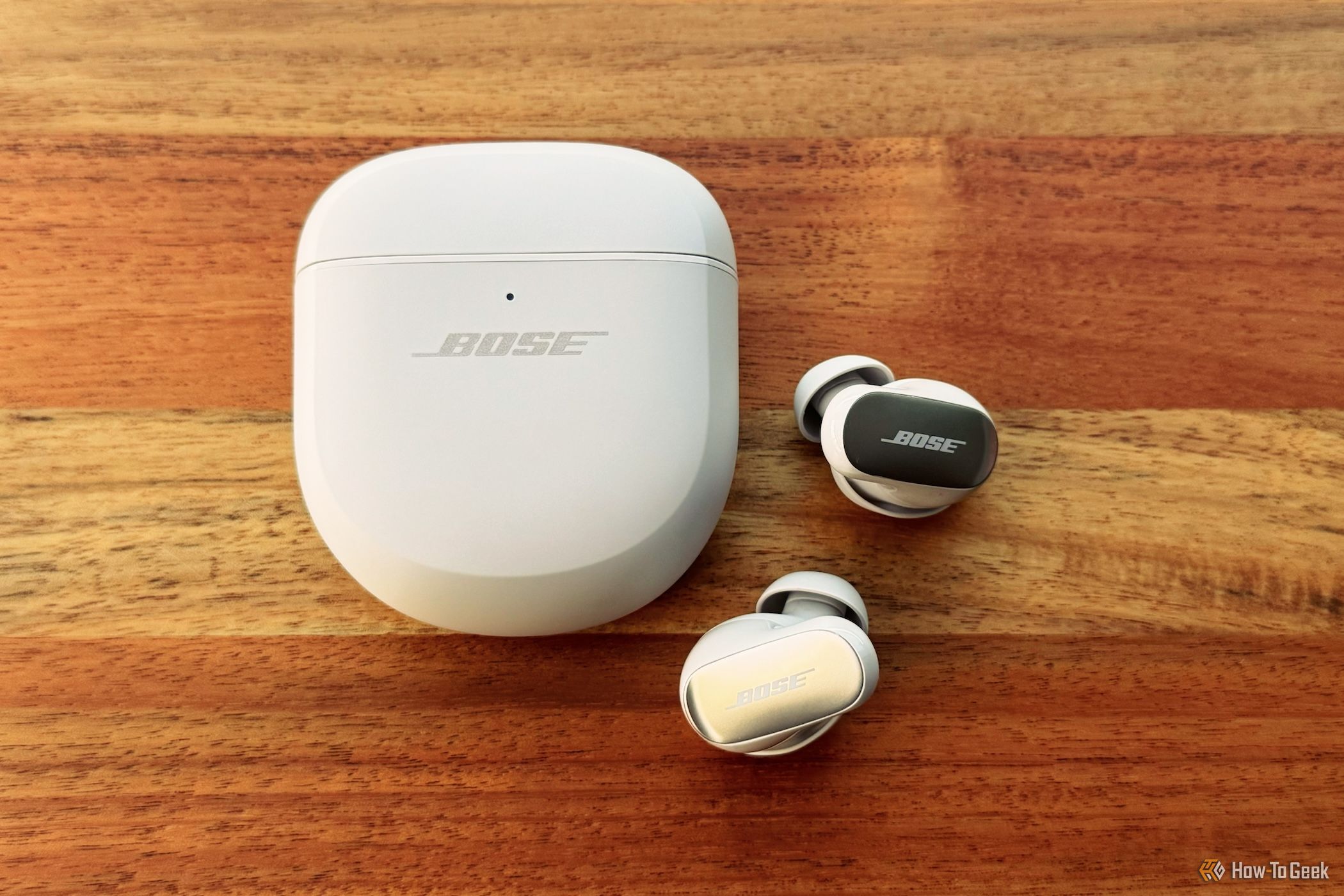 Bose QuietComfort Ultra Earbuds next to their charging case