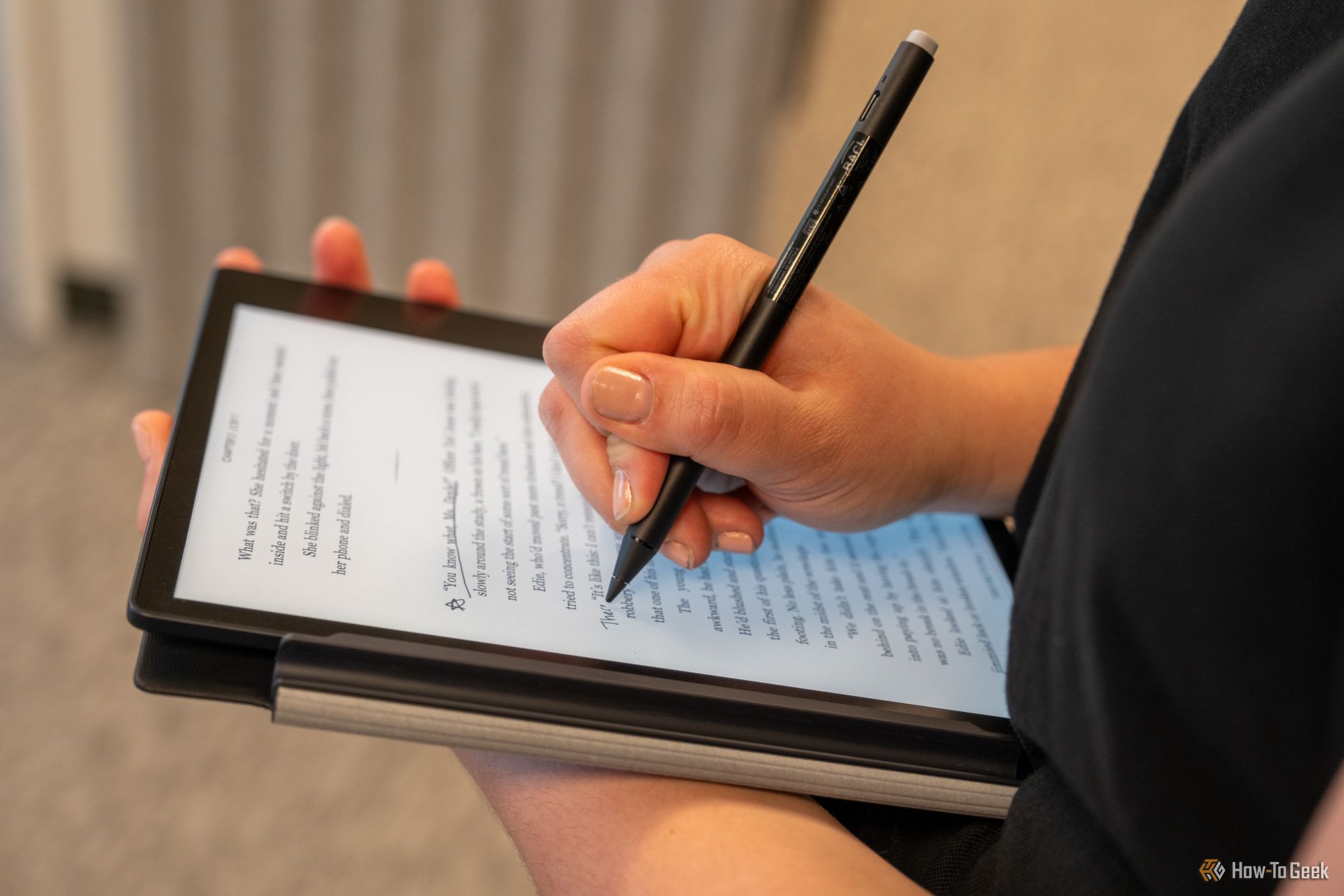 The Kobo Elipsa 2E in a person's hands while taking notes.