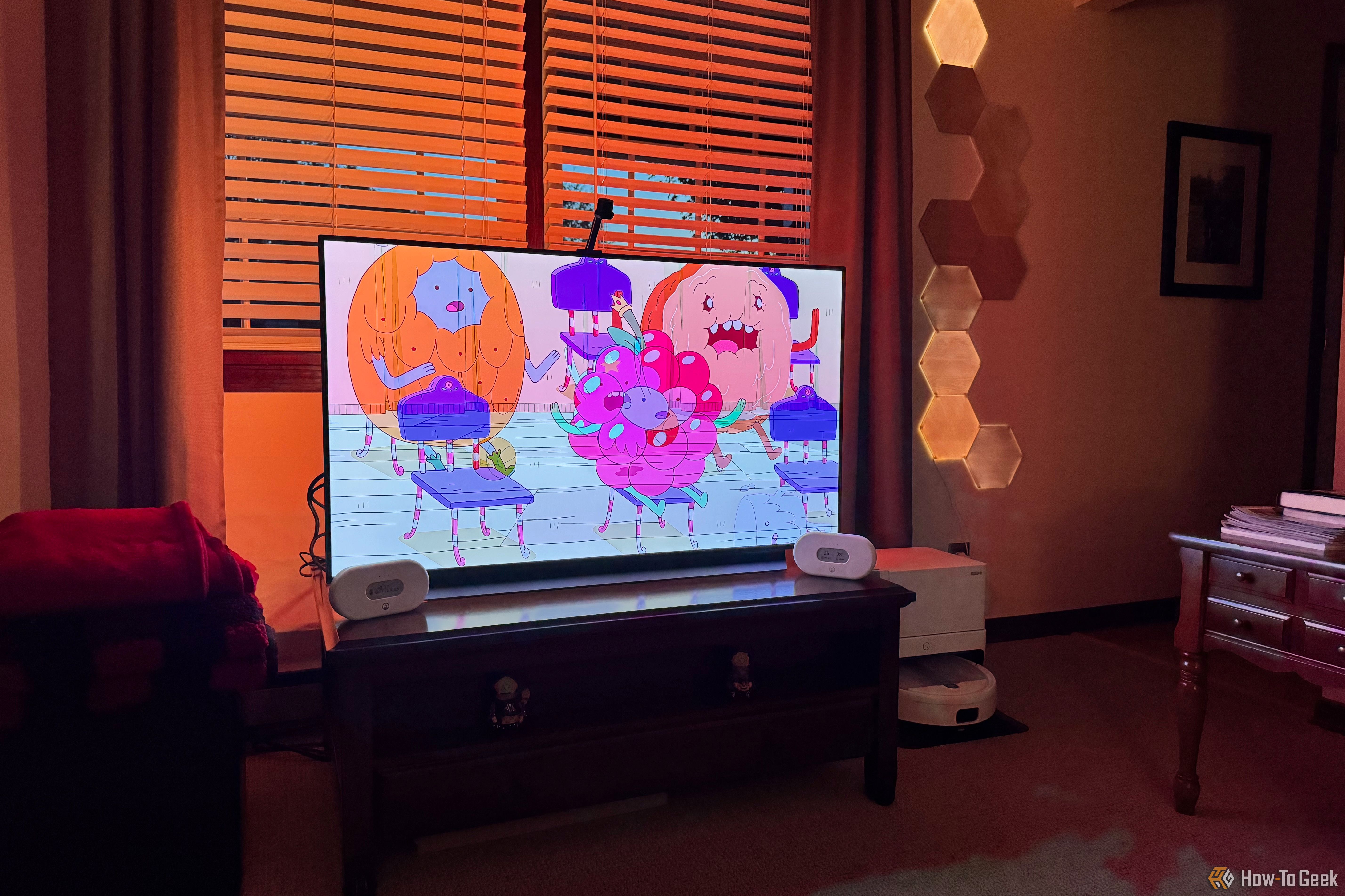 A TV showing lights shining on the sides thanks to Nanoleaf 4D.