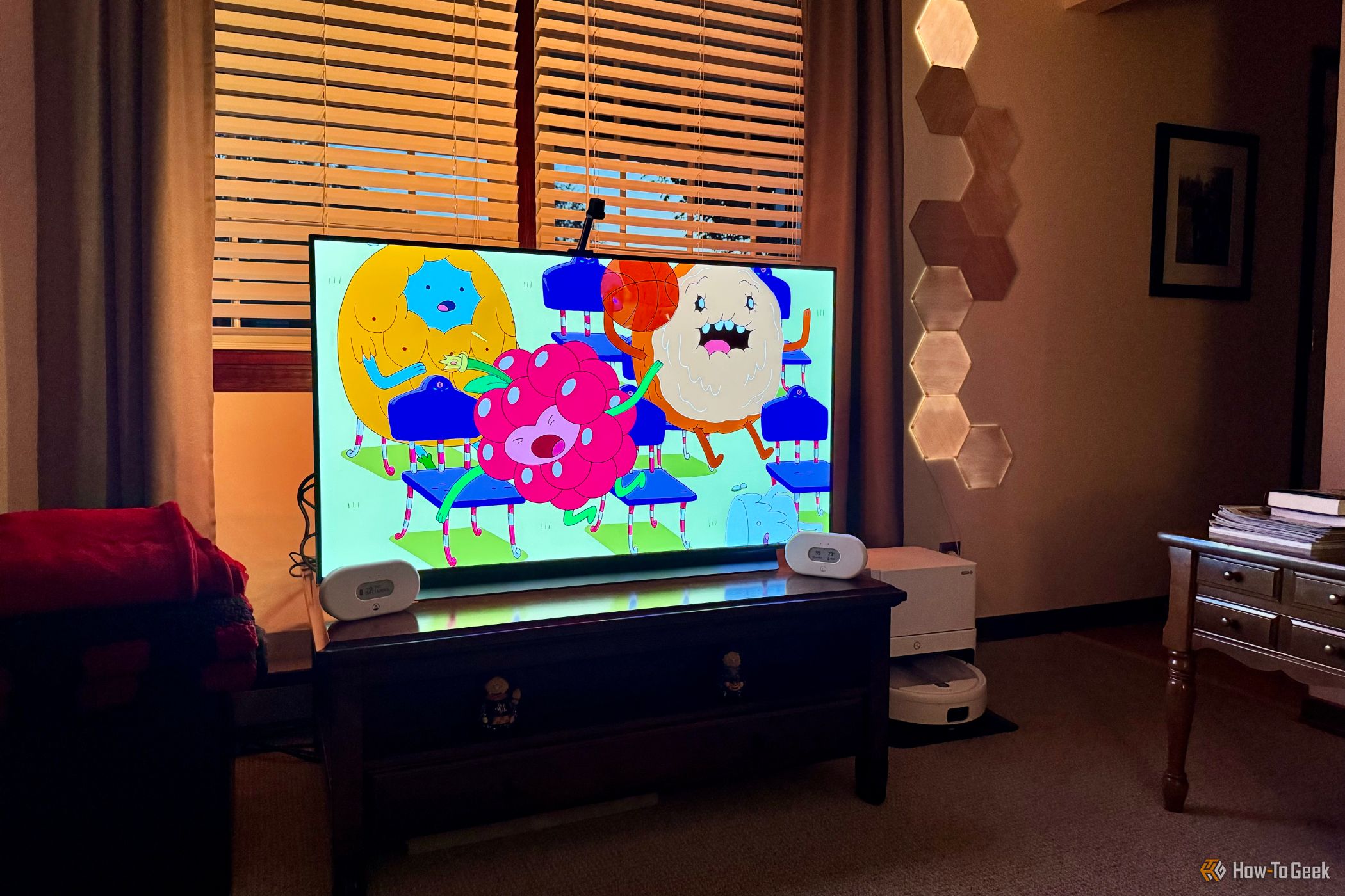Smart TV in a living room showing Nanoleaf 4D lights on all four sides