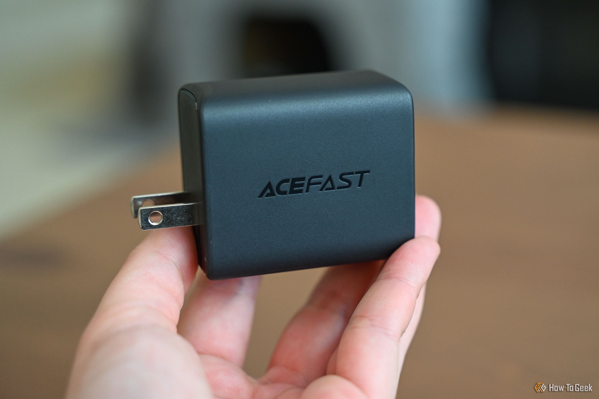 Person holding the ACEFAST GaN PD65W 3 Port Fast Charger Hub