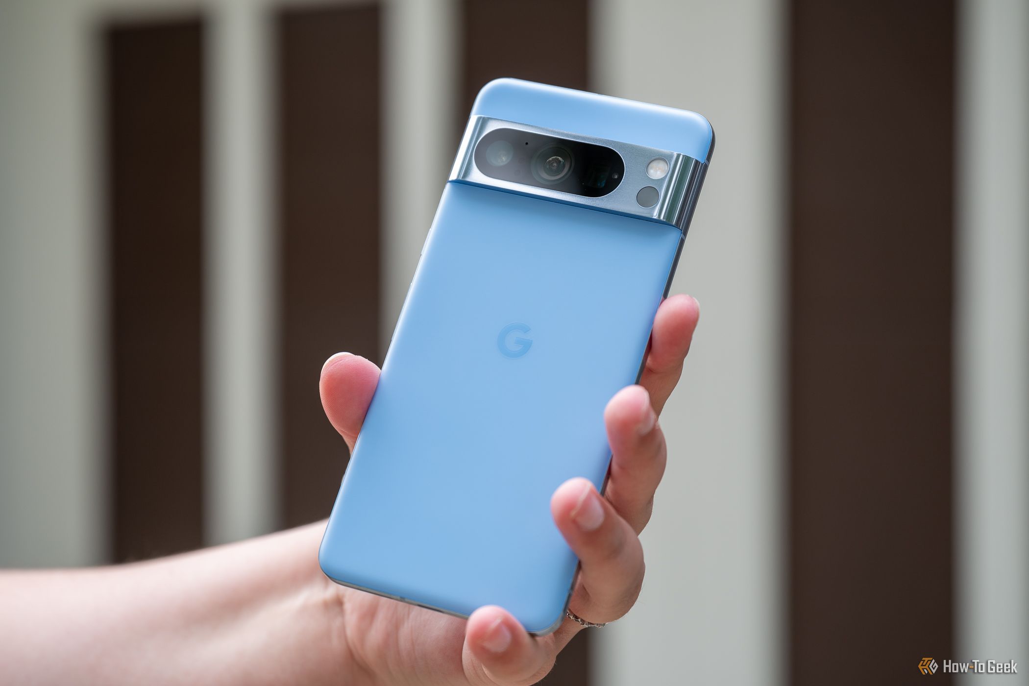 Person holding the back of the Google Pixel 8 Pro
