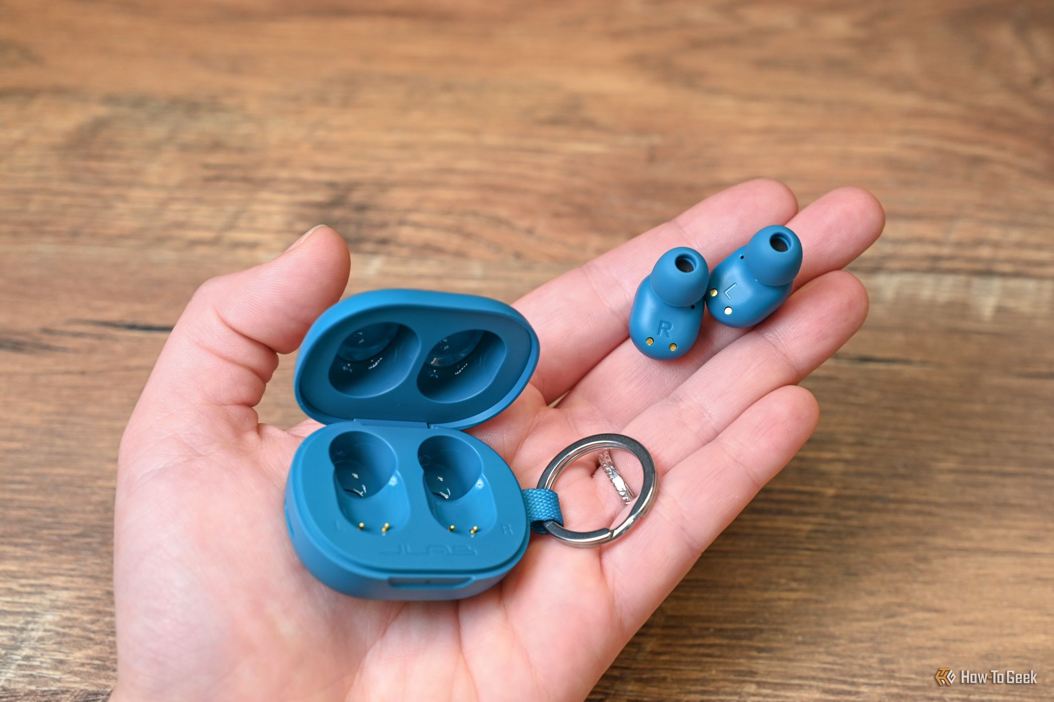 A person holding the JLab JBuds Mini.