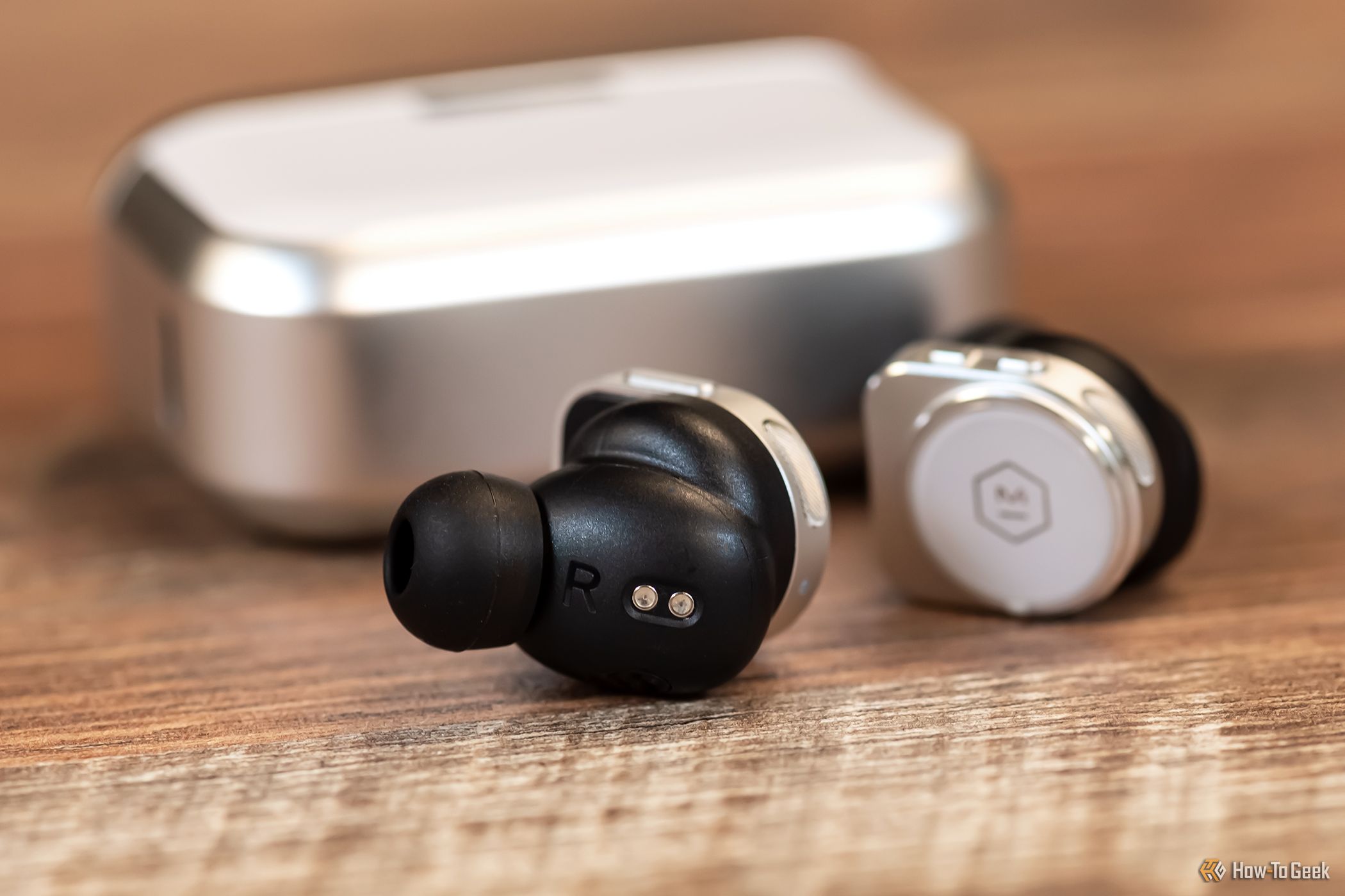 master & dynamic mw09 earbuds in front of the case