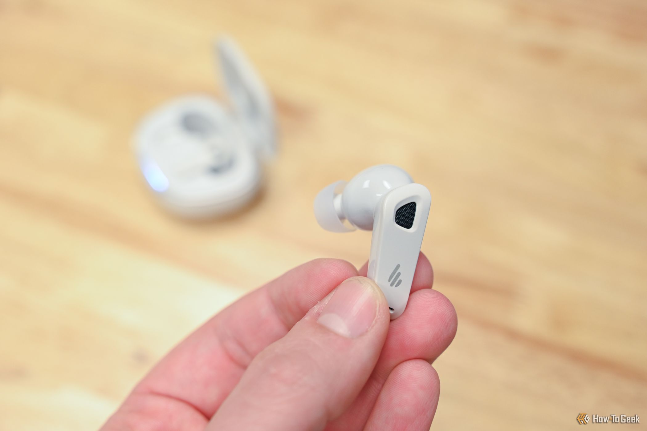 Person holding an Edifier NeoBuds Pro 2 earbud