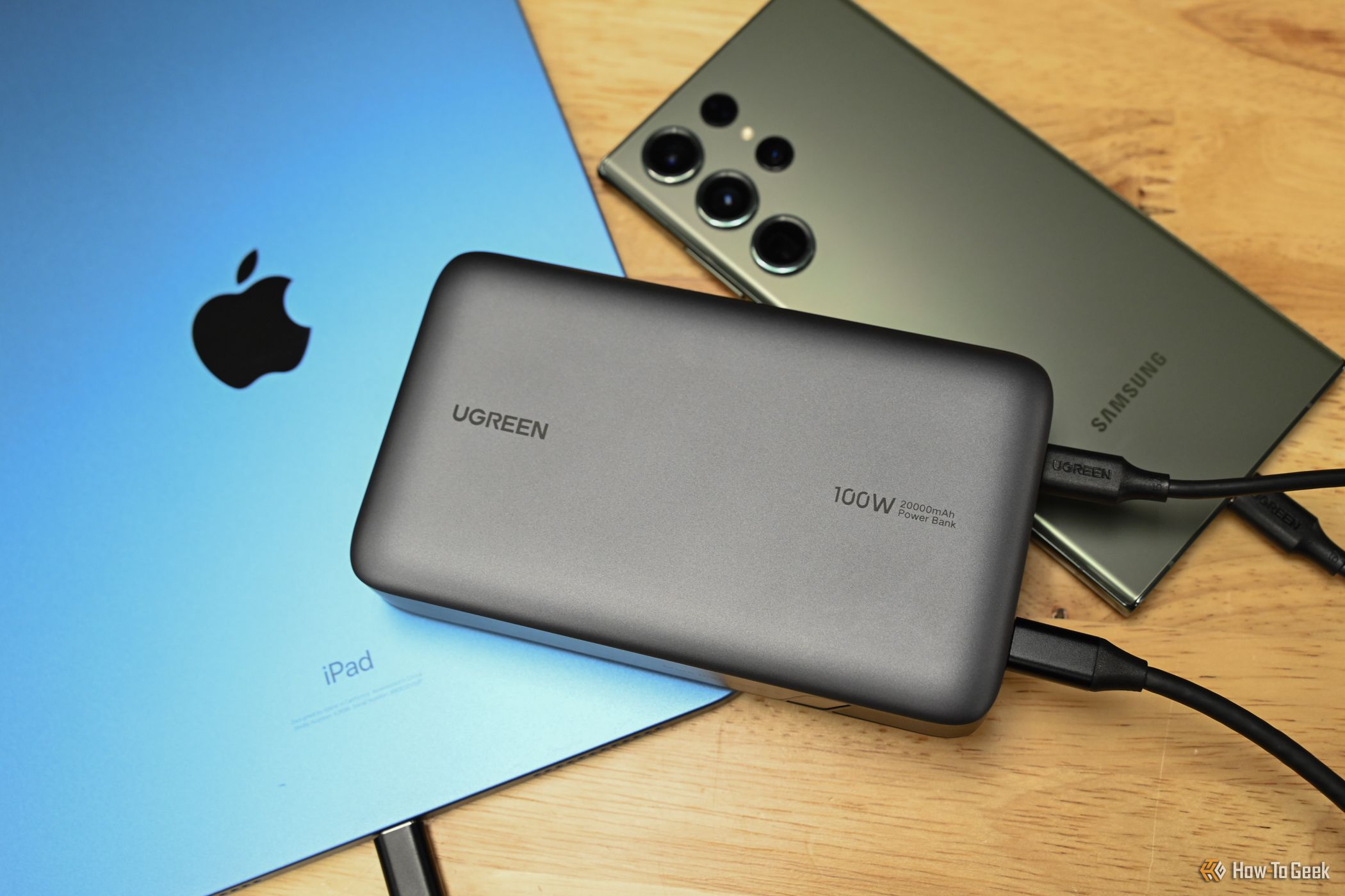 Charging a Samsung phone and an iPad with the Ugreen 20,000mAh Two-Way Fast Charging Power Bank