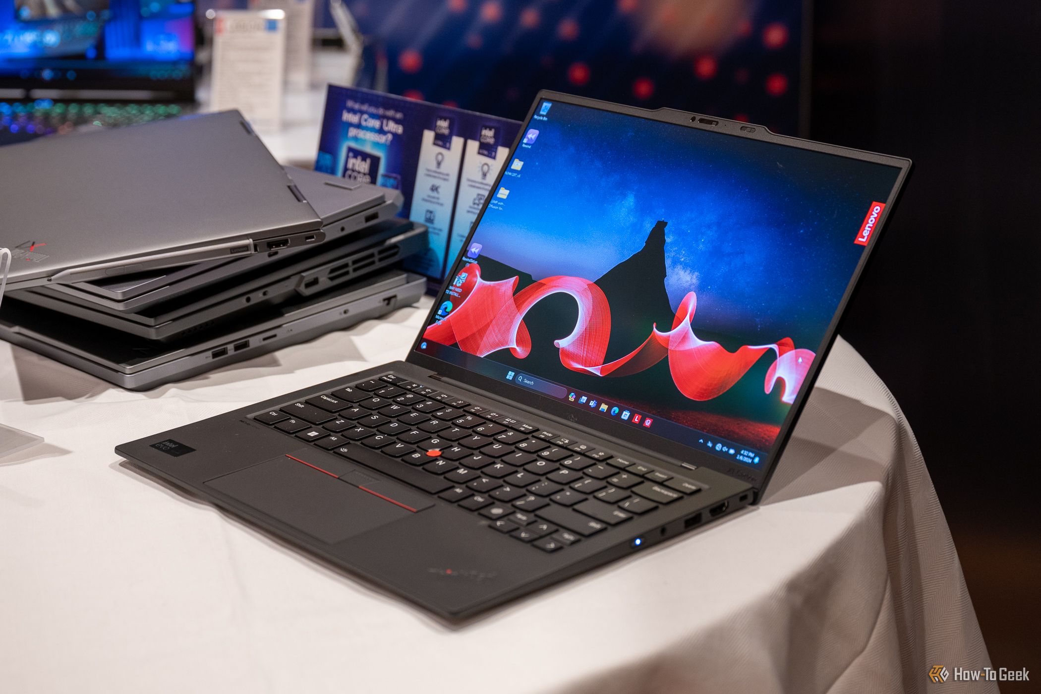 Lenovo ThinkPad X1 Carbon Gen 12 sitting on a table open showing its screen and keyboard.