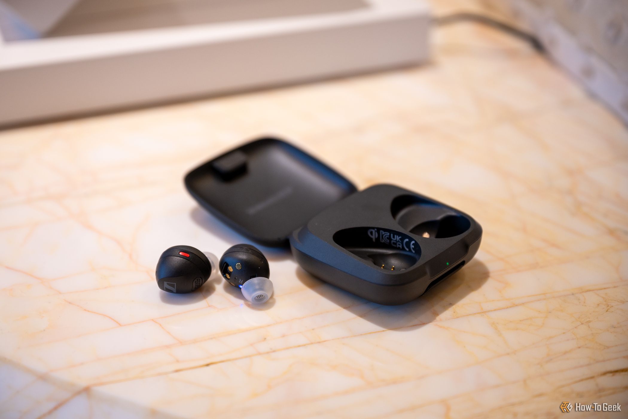 Sennheiser Momentum Sport earbuds sitting outside of their charging case at CES 2024.