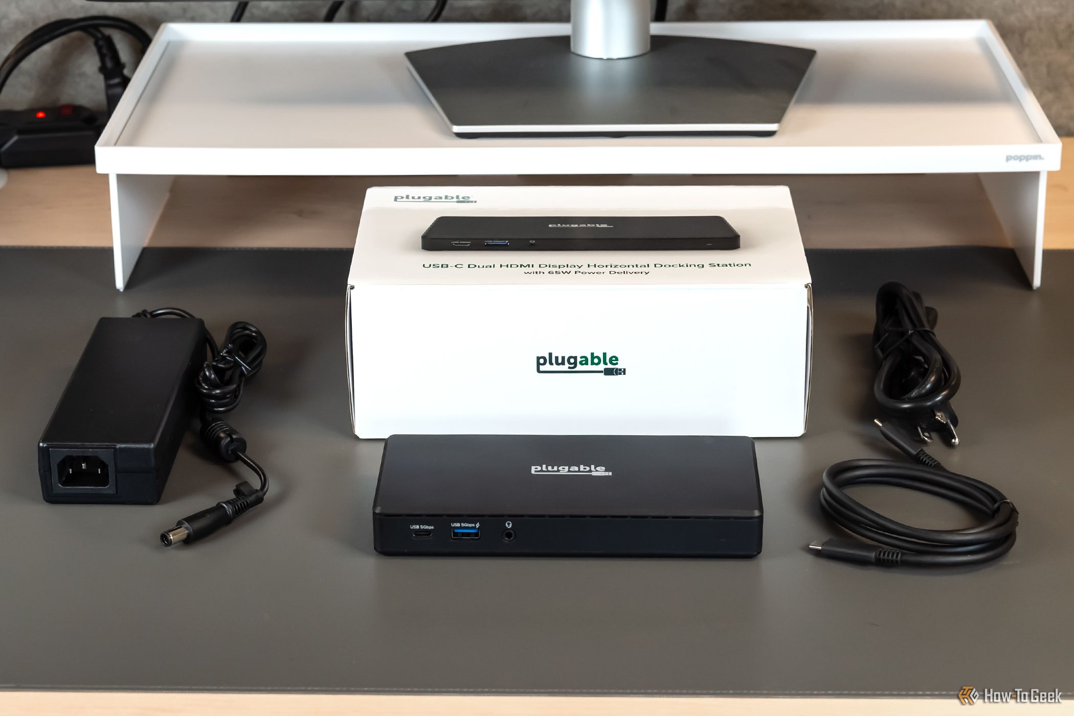 The Plugable USB C Dual HDMI Docking Station with the provided cables and its box