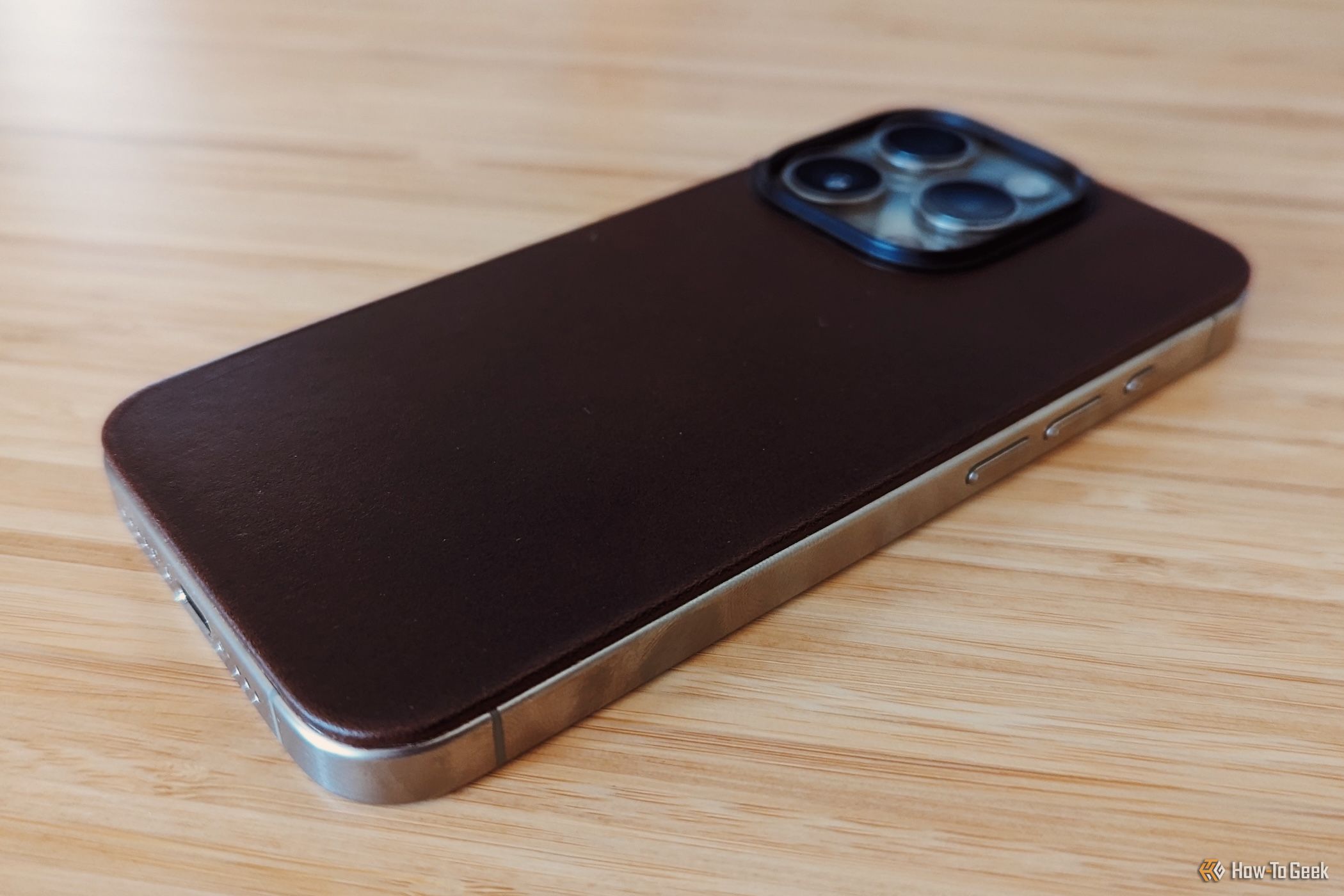 Angled side view of Nomad Magnetic Leather Back on iPhone 15 Pro