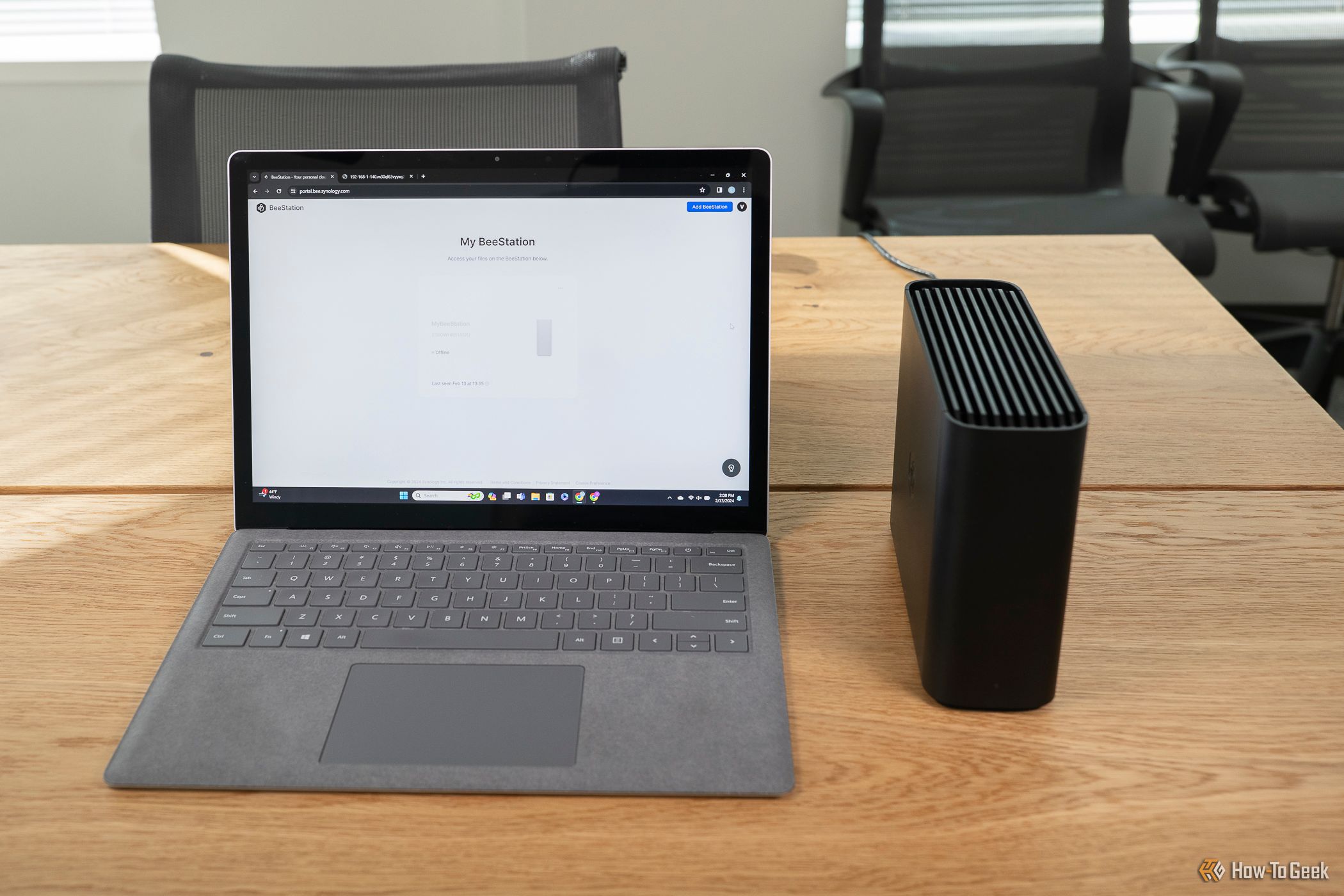 The Synology BeeStation next to a Microsoft Surface tablet.