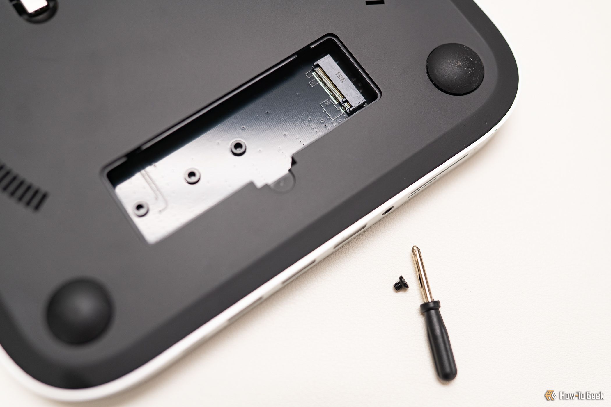 Close up of the NVME slot of the Satechi Stand and Hub for Mac with included screwdriver and screw