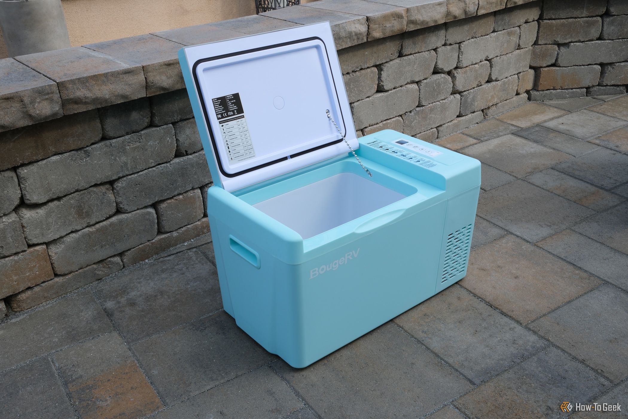 Distant view of BougeRV CR 12V Mini Fridge with the lid open