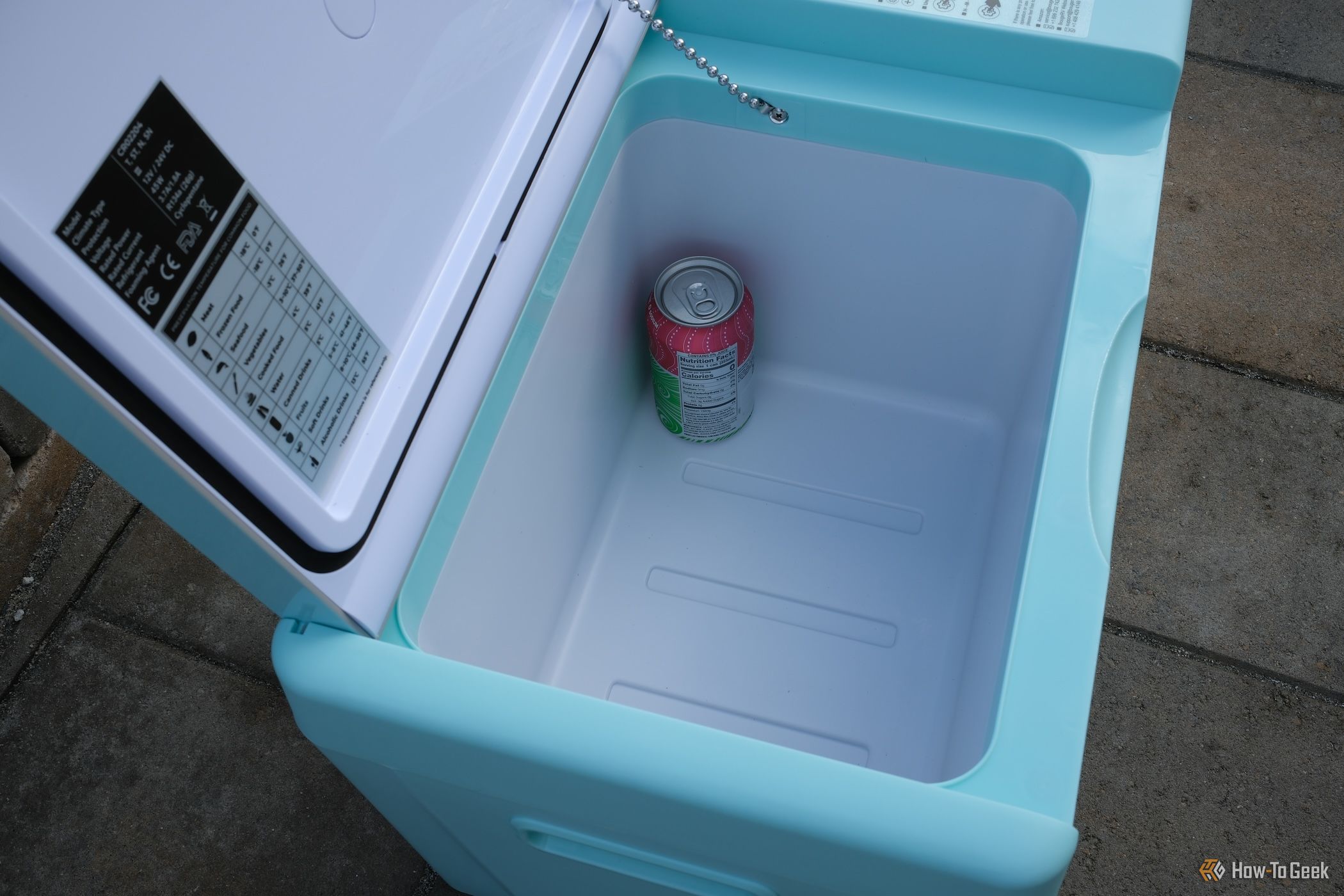 View inside the BougeRV CR 12V Mini Fridge with a drink