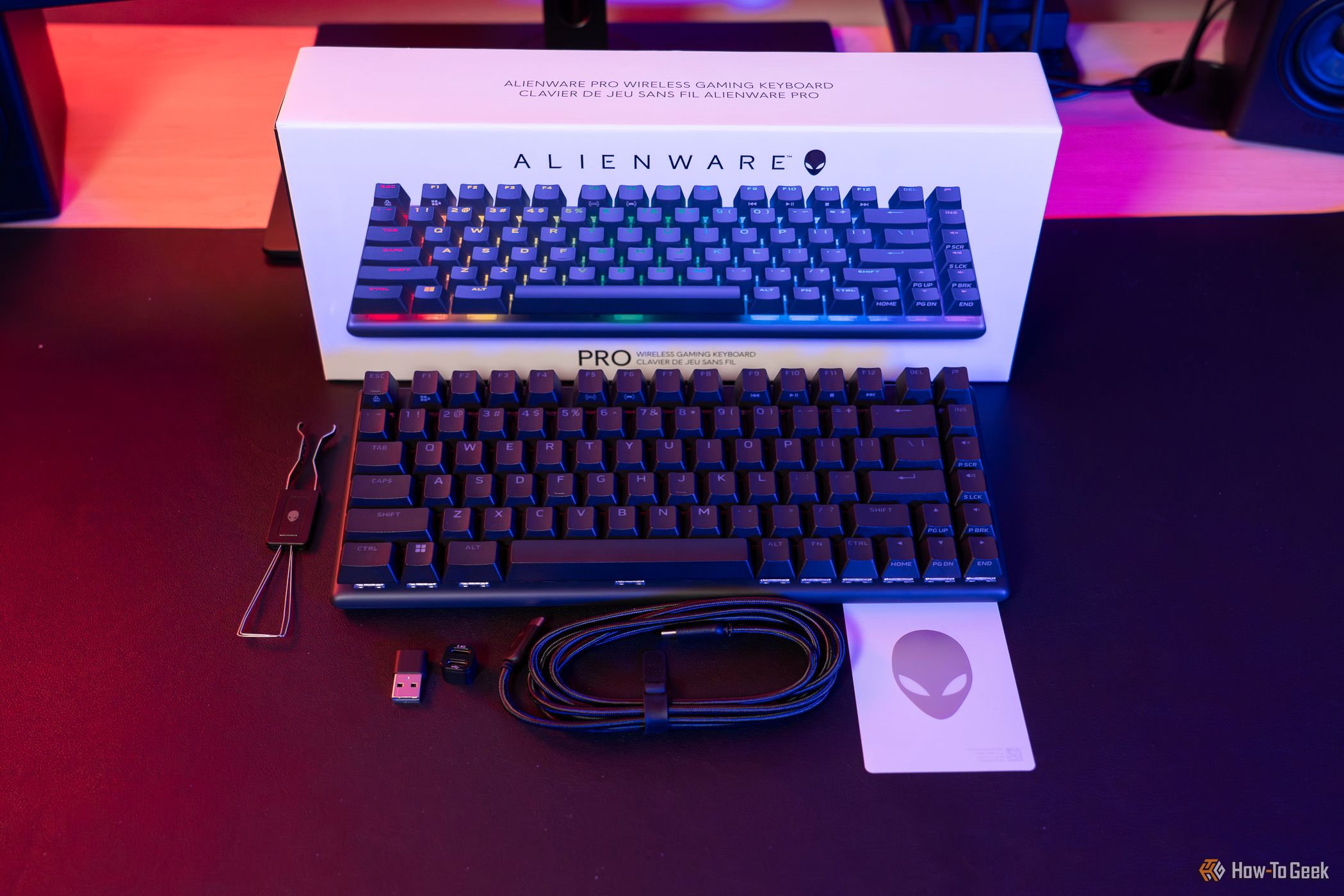A black Alienware Pro Wireless Keyboard with box and accessories