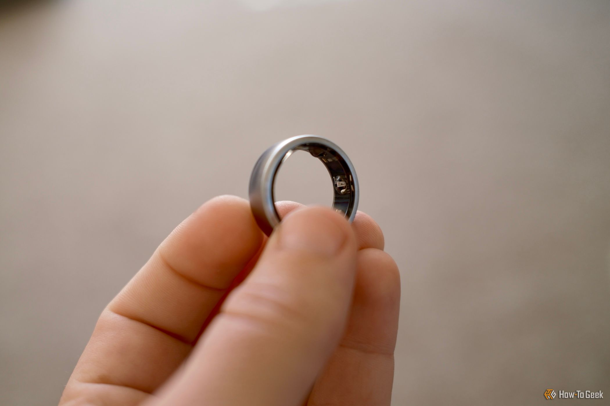 Oura Ring held in a hand