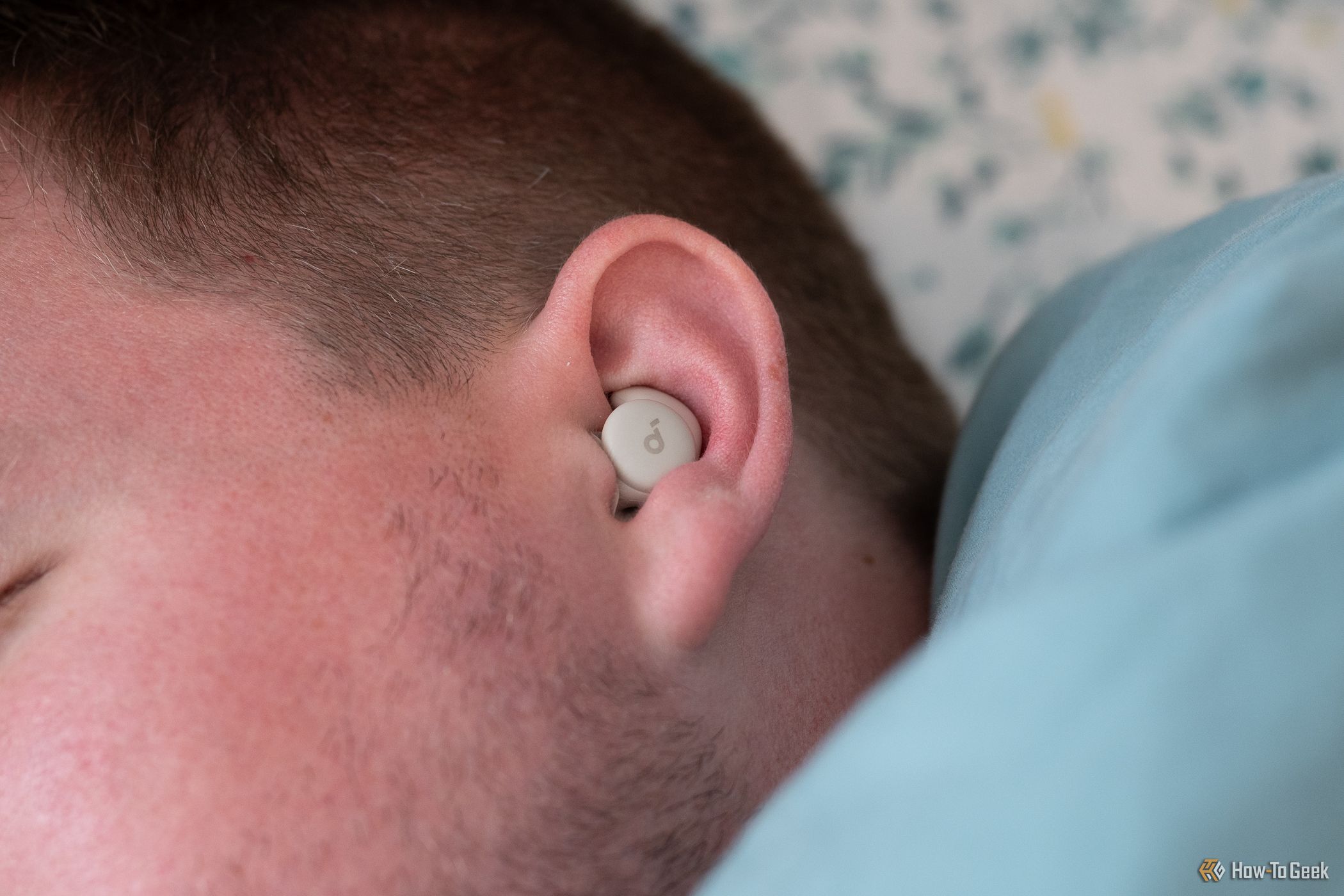 Person asleep with the Soundcore Sleep A20 Bluetooth Earbuds in their ear