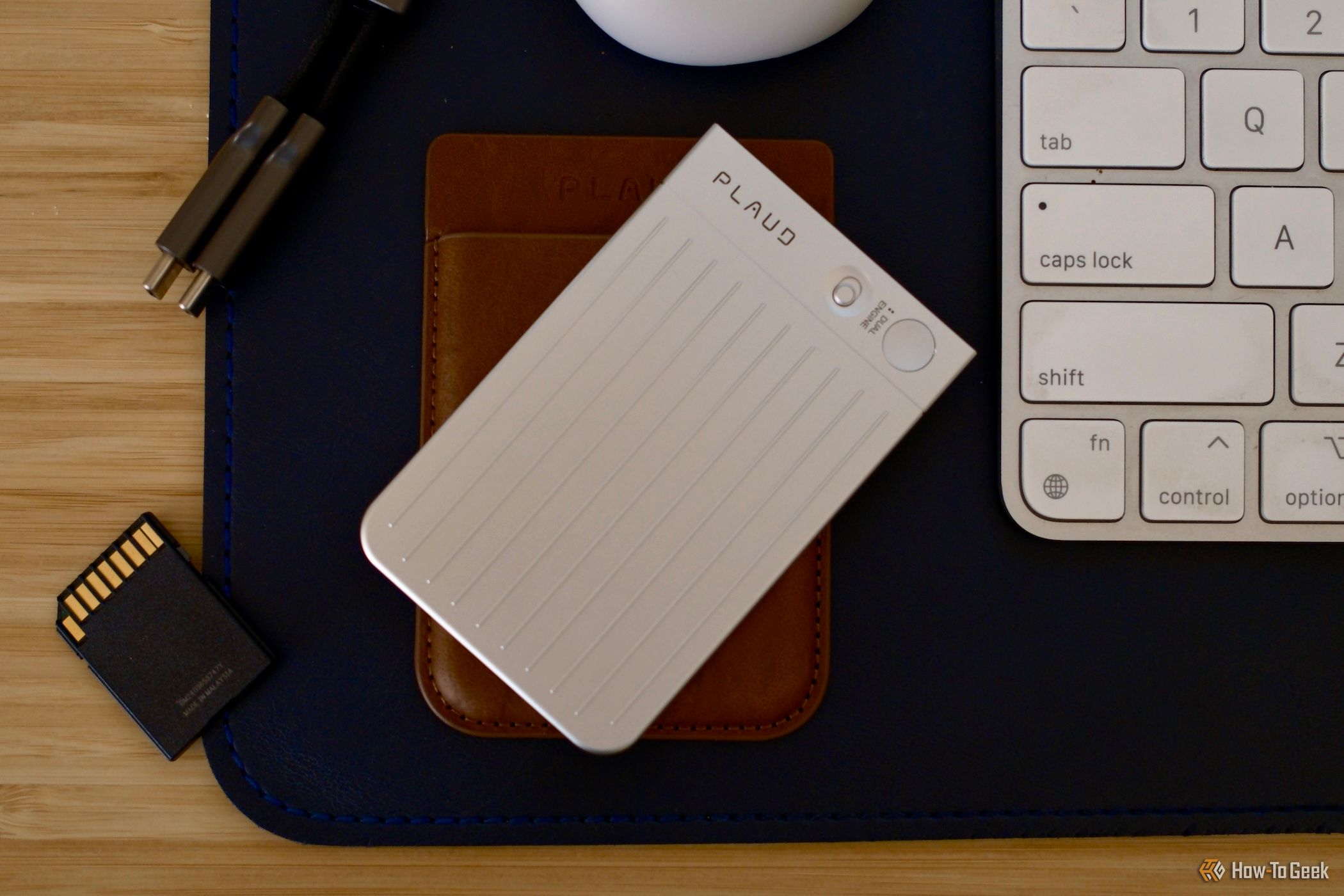 Plaud Note on top of its case laying on a desk
