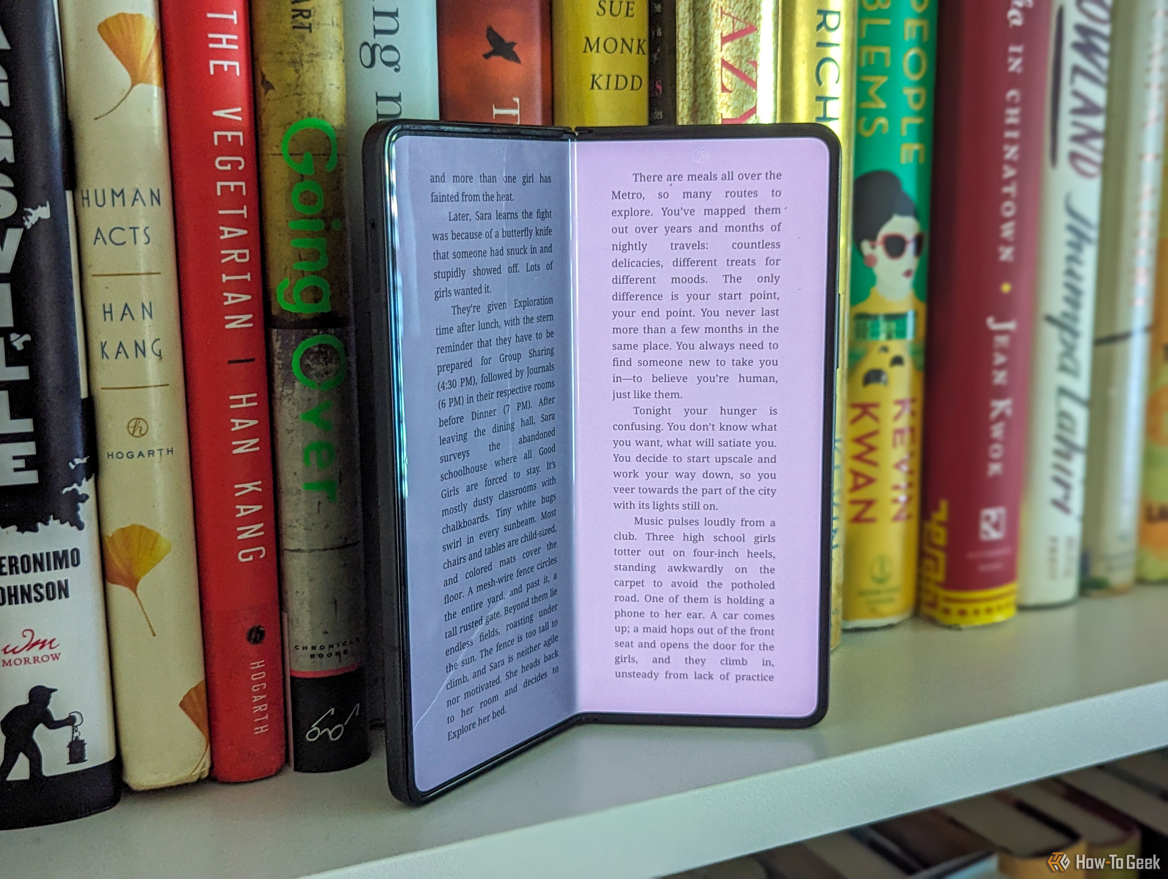A slightly open Galaxy Z Fold 5 on a bookshelf