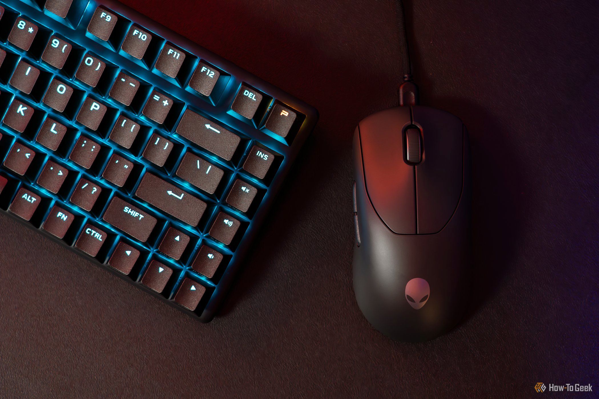 A black Alienware Pro Wireless Gaming Mouse next to an Alienware keyboard.