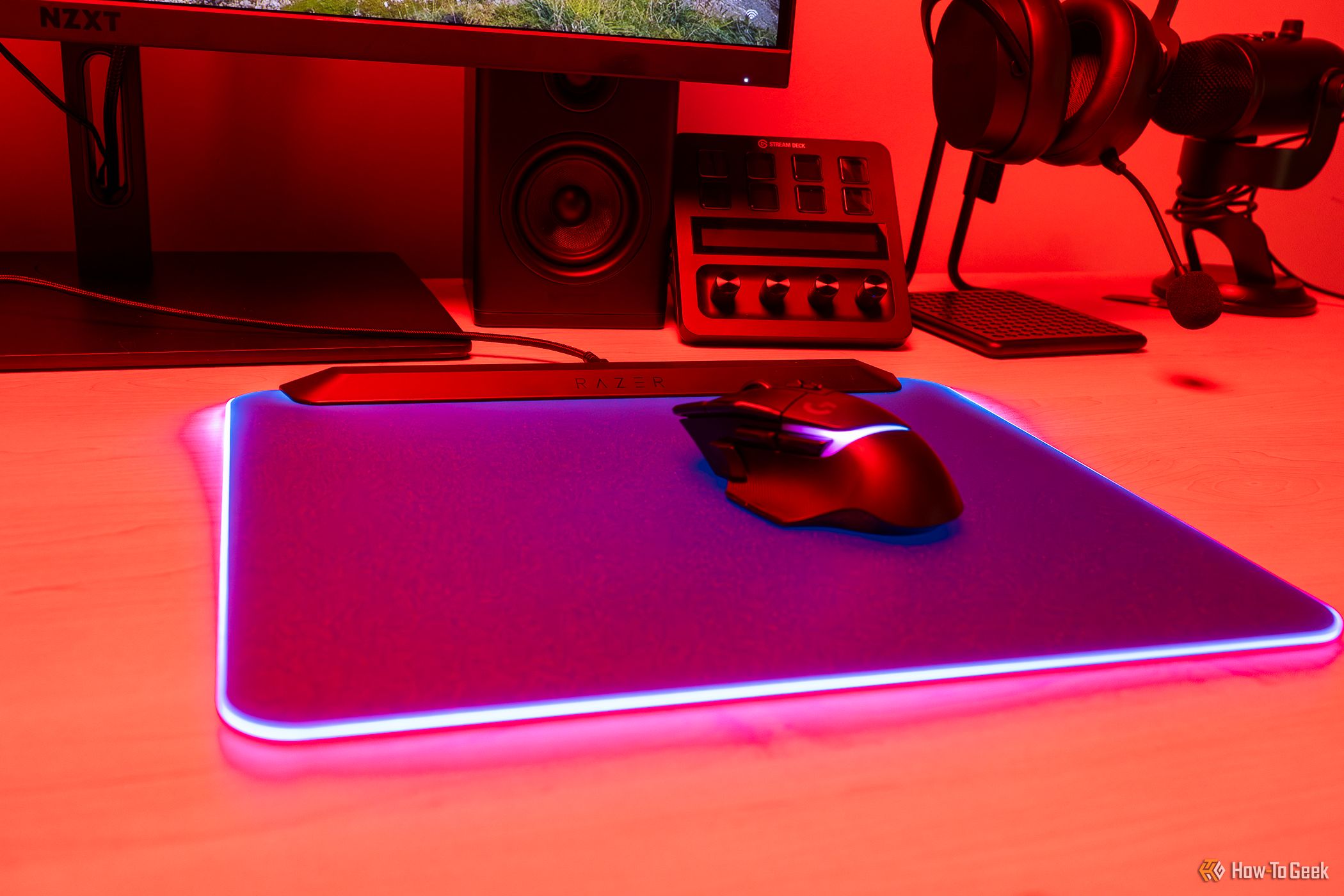 A Razer Firefly V2 Pro gaming mouse on a light-up mouse pad.