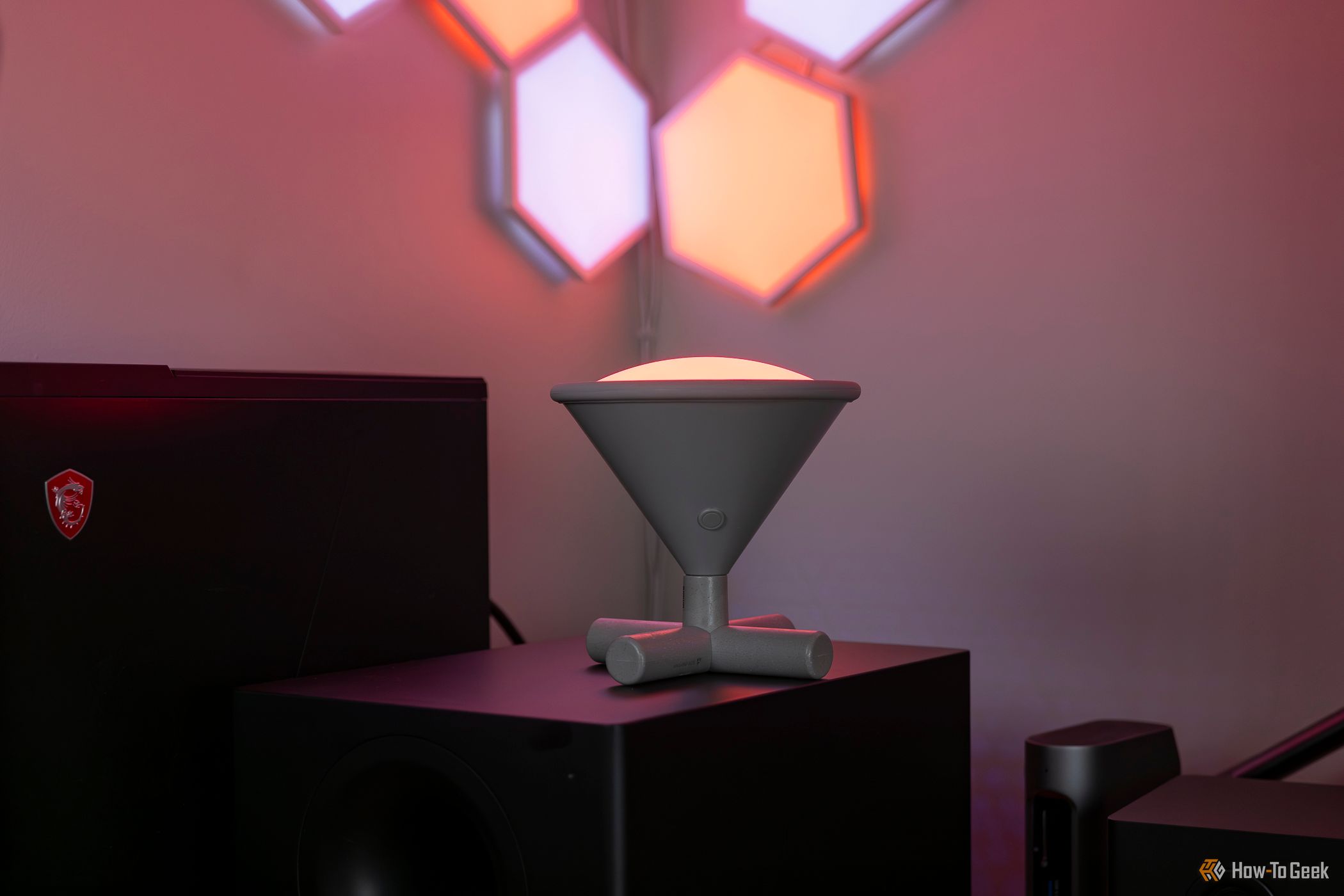 Nanoleaf Umbra Cono in a dark room standing up with its light on