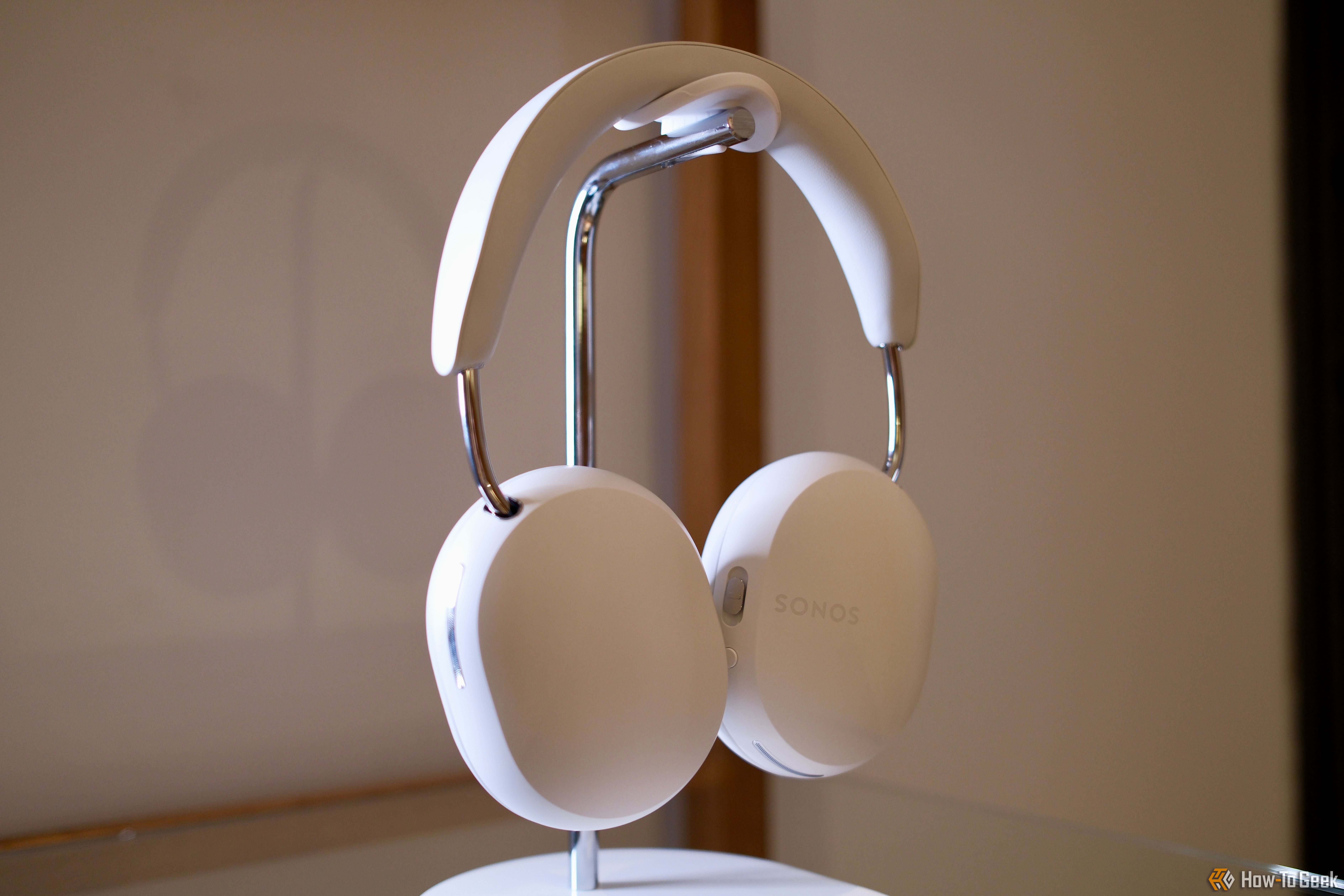 Sonos Ace headphones hanging on a stand