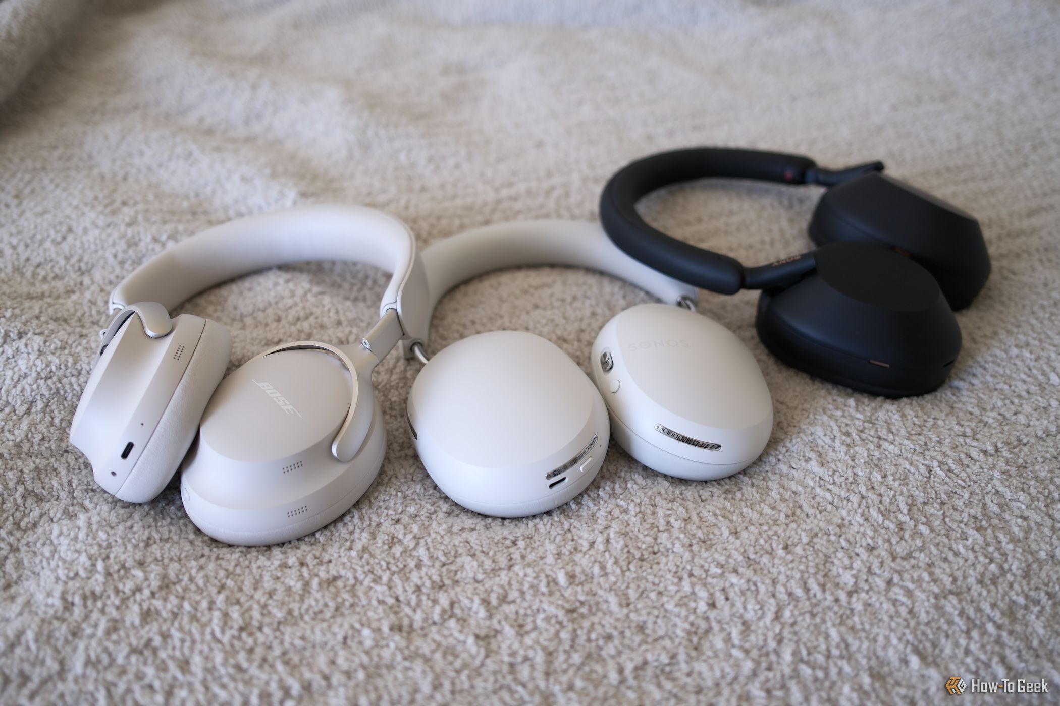 Sonos Ace laying next to Bose and Sony headphones