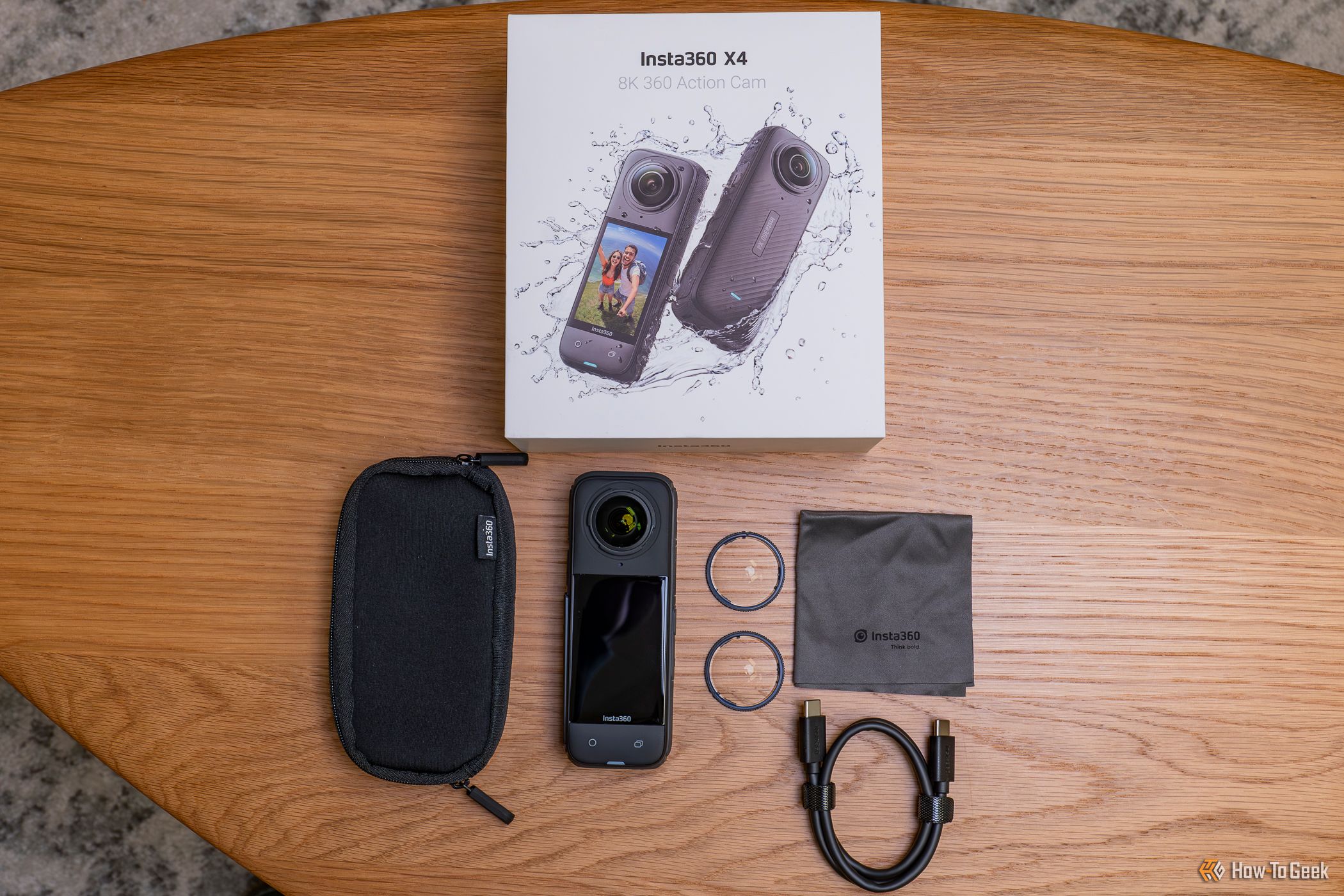 The Insta360 X4 next to box and included accessories
