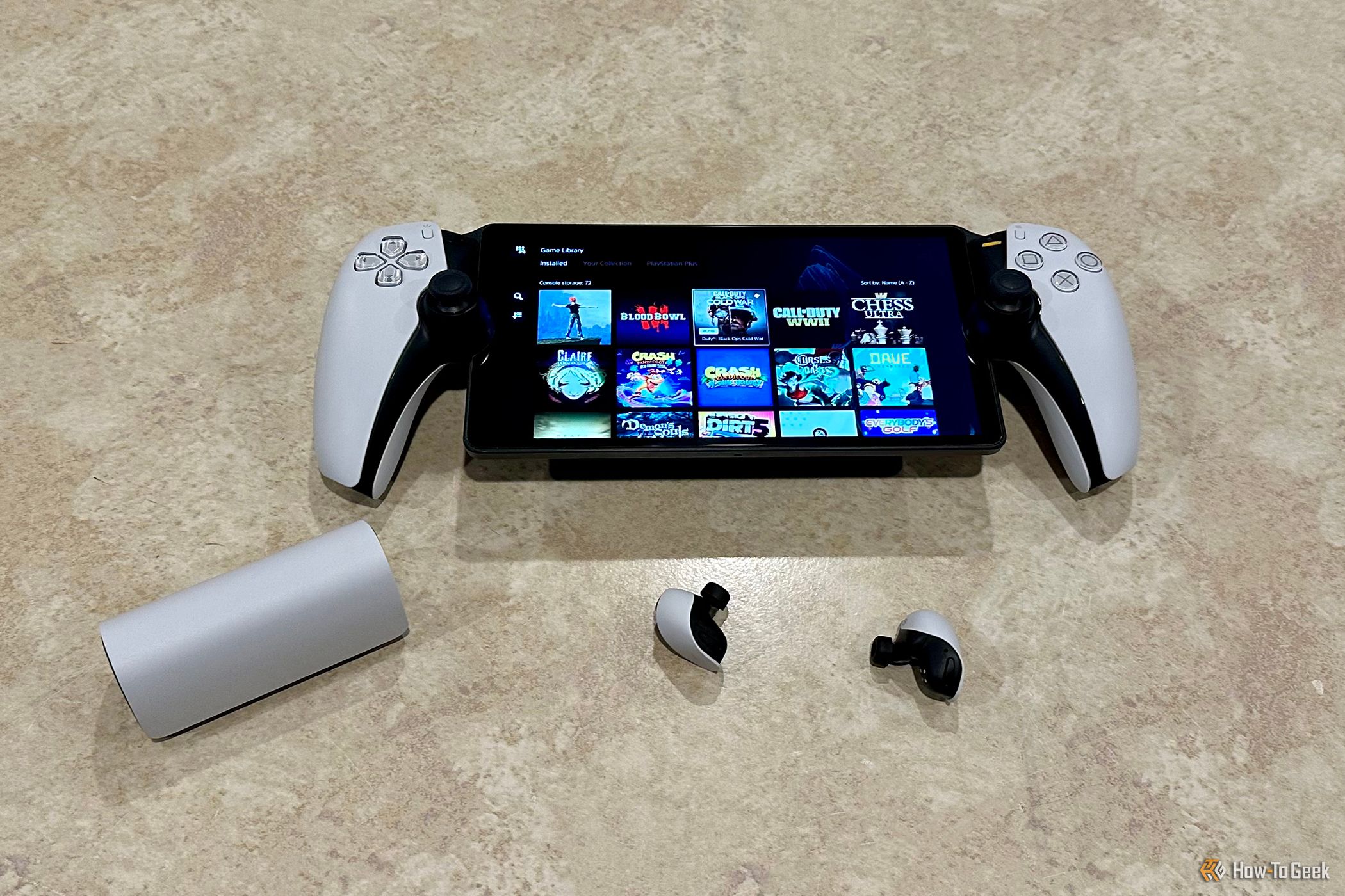 Sony PlayStation Portal, Pulse Explore Wireless Earbuds, and Charging Case on a tabletop