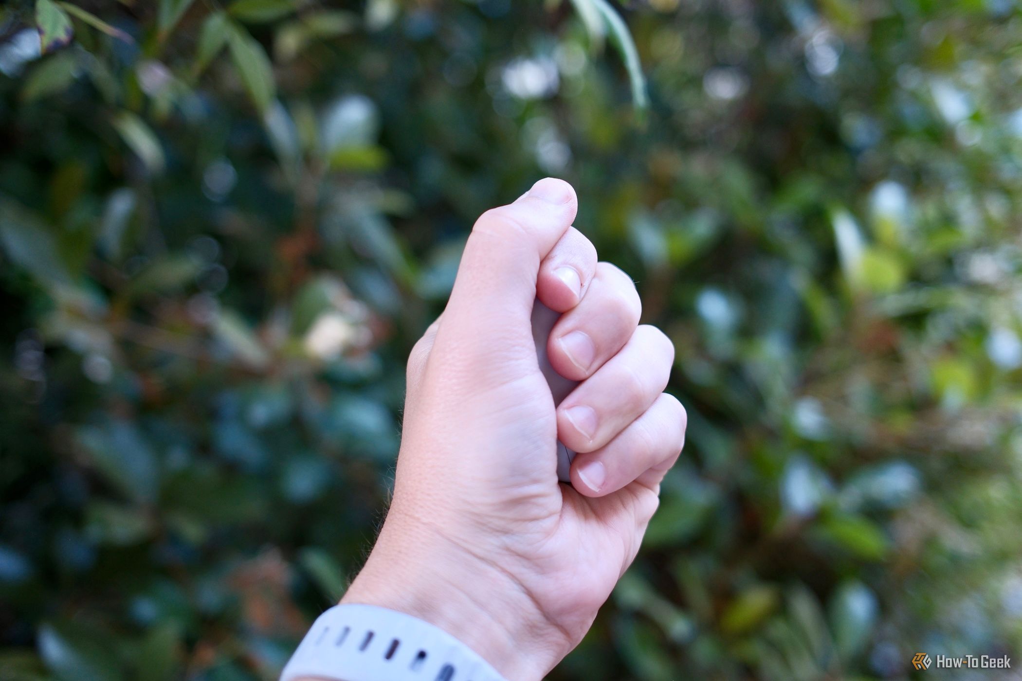 Beats Solo Buds being gripped in a hand