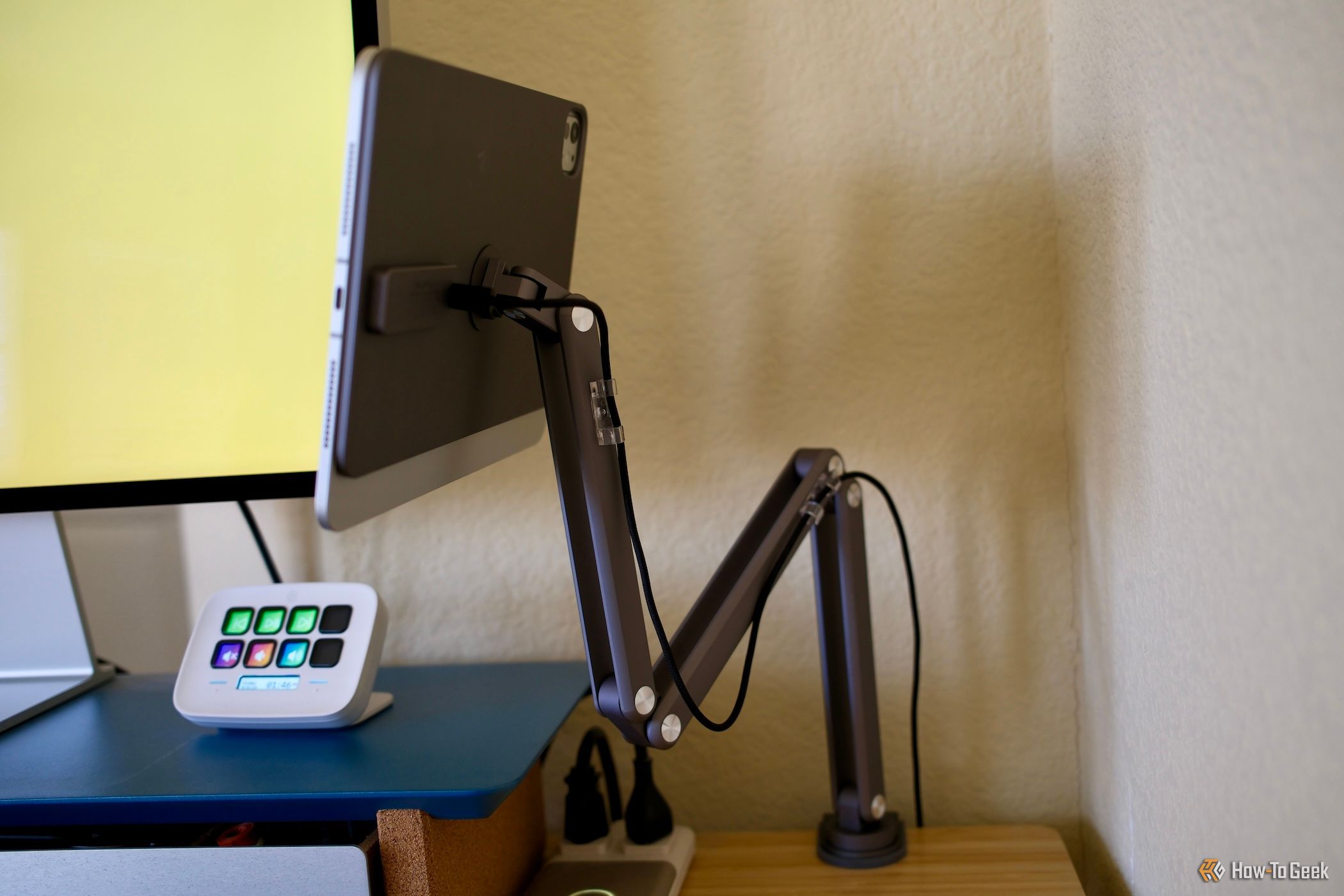 side view of the Kuxiu X36 Pro Max iPad Stand attached to a desk