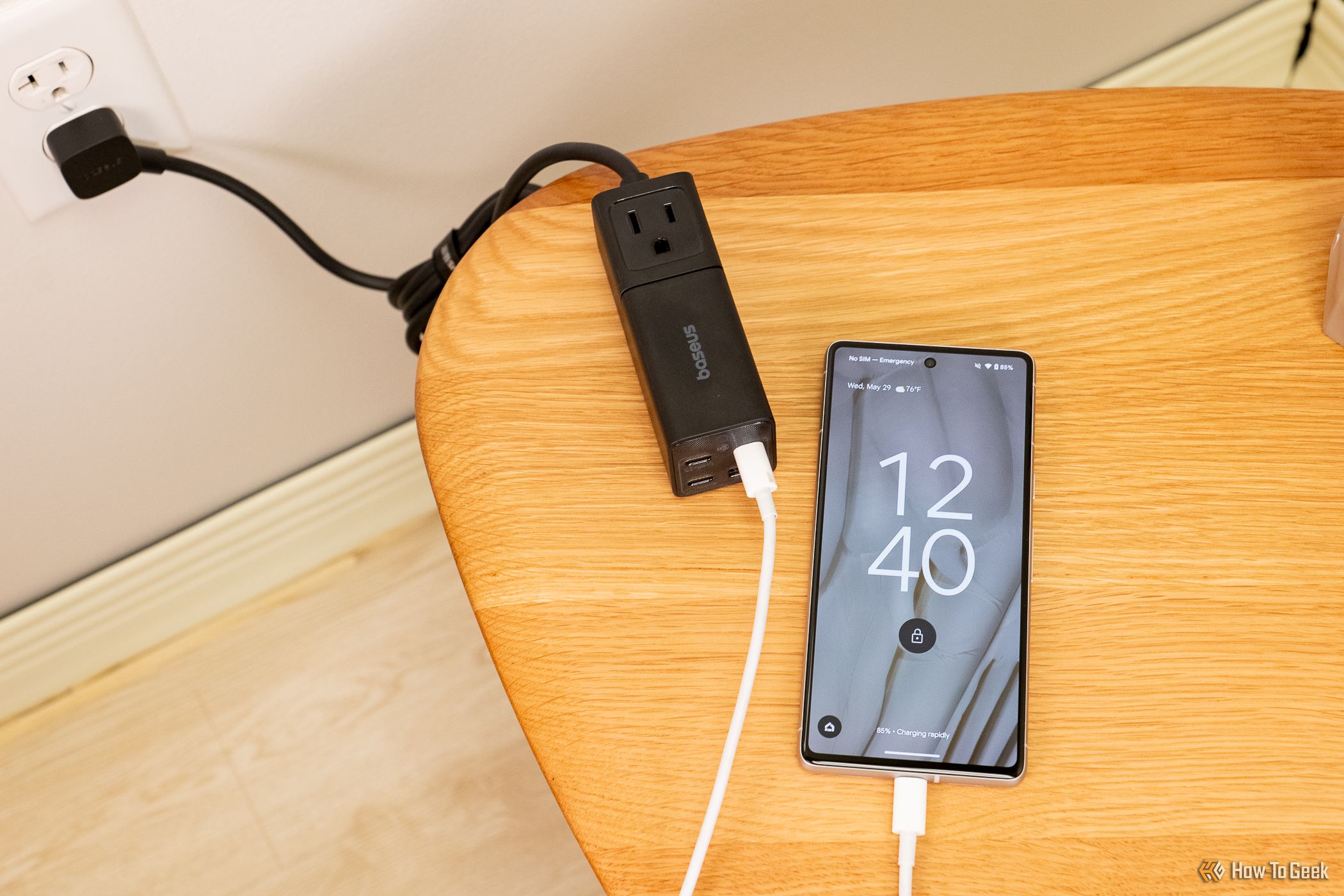 Baseus PowerCombo Mini 5-in-1 Power Strip charging a phone