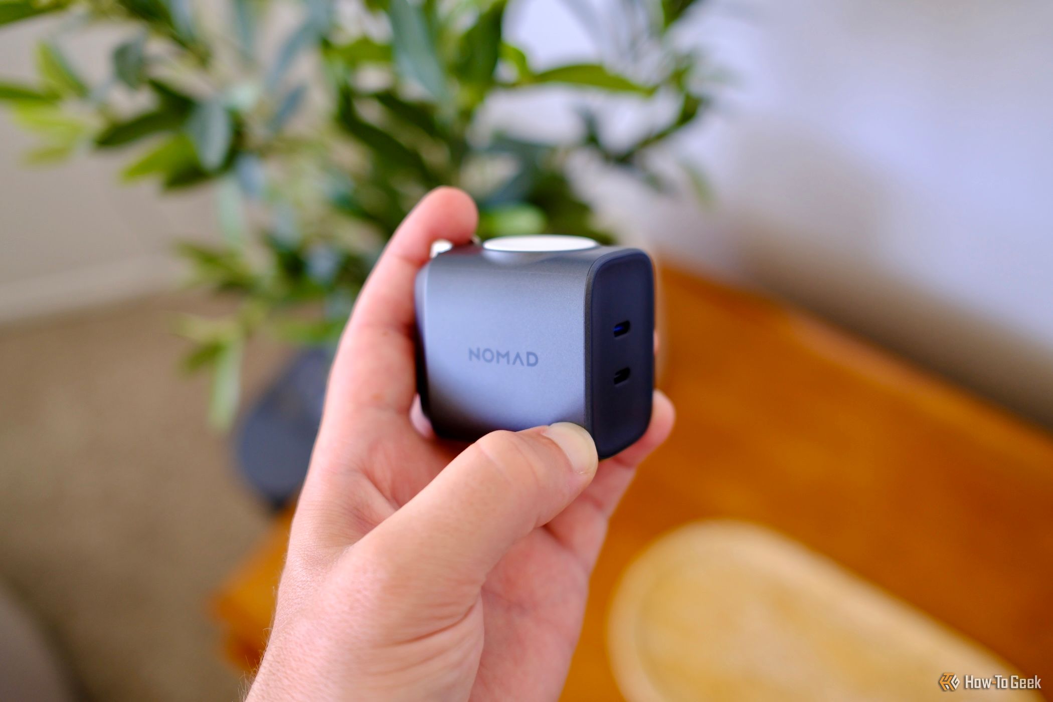 hand holding the Nomad 65W Power Adapter Watch Edition