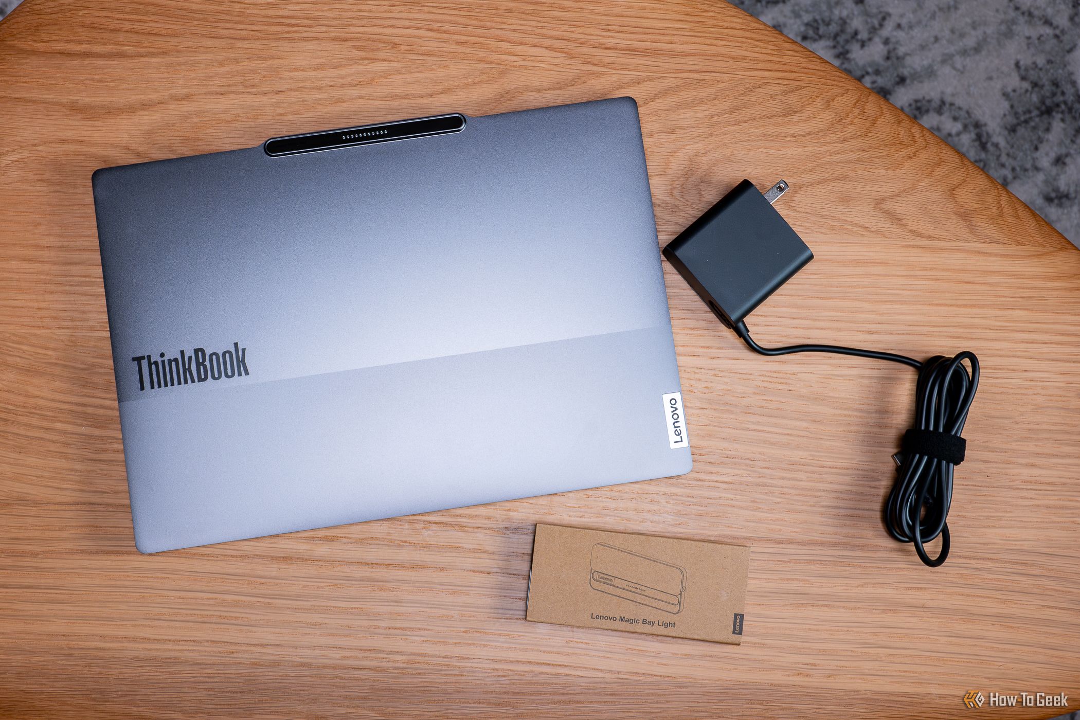 The Lenovo ThinkBook 13x Gen 4 with light and charging cable.