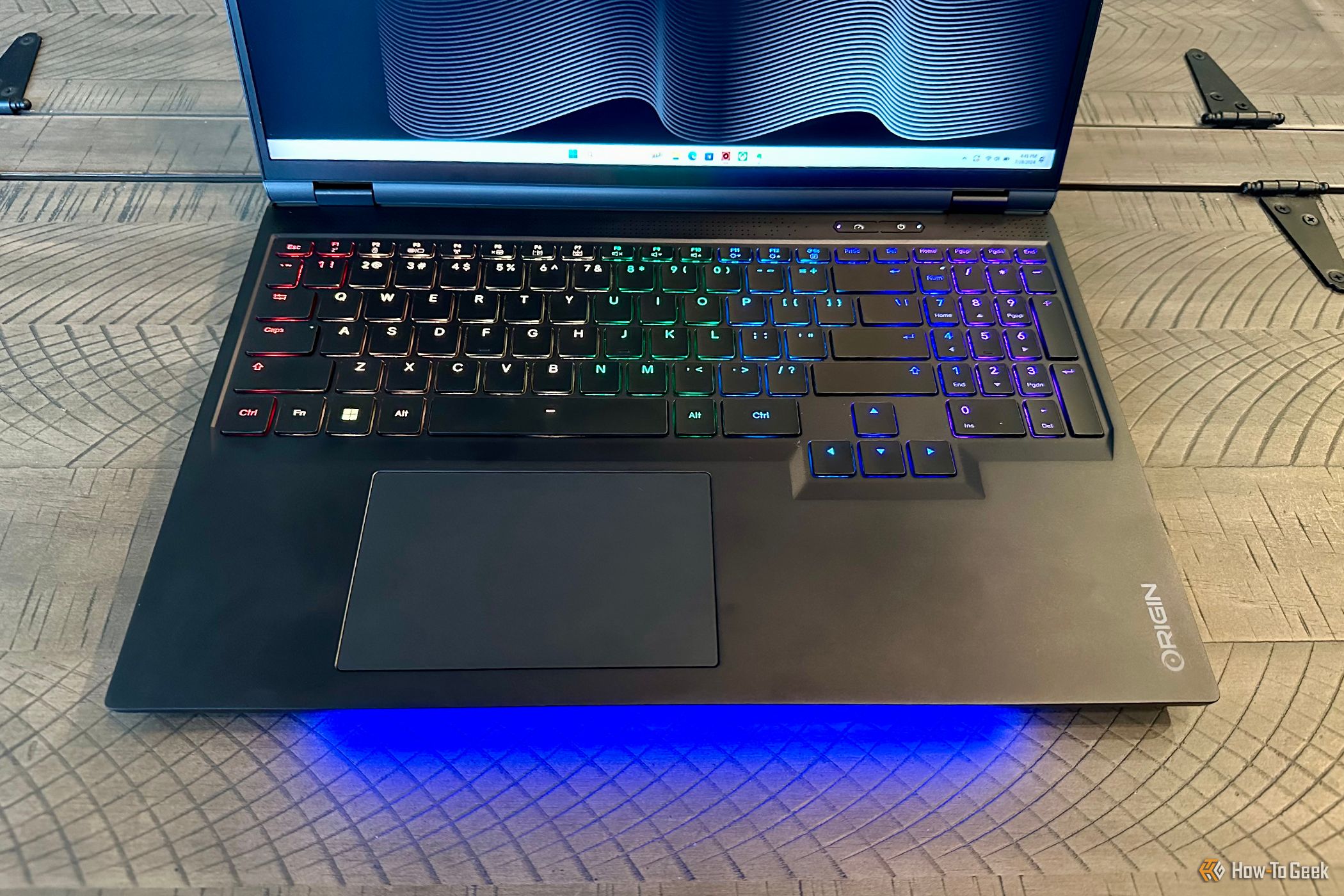 Origin PC EON16-X Laptop open on a table top with a close up of the keyboard and trackpak