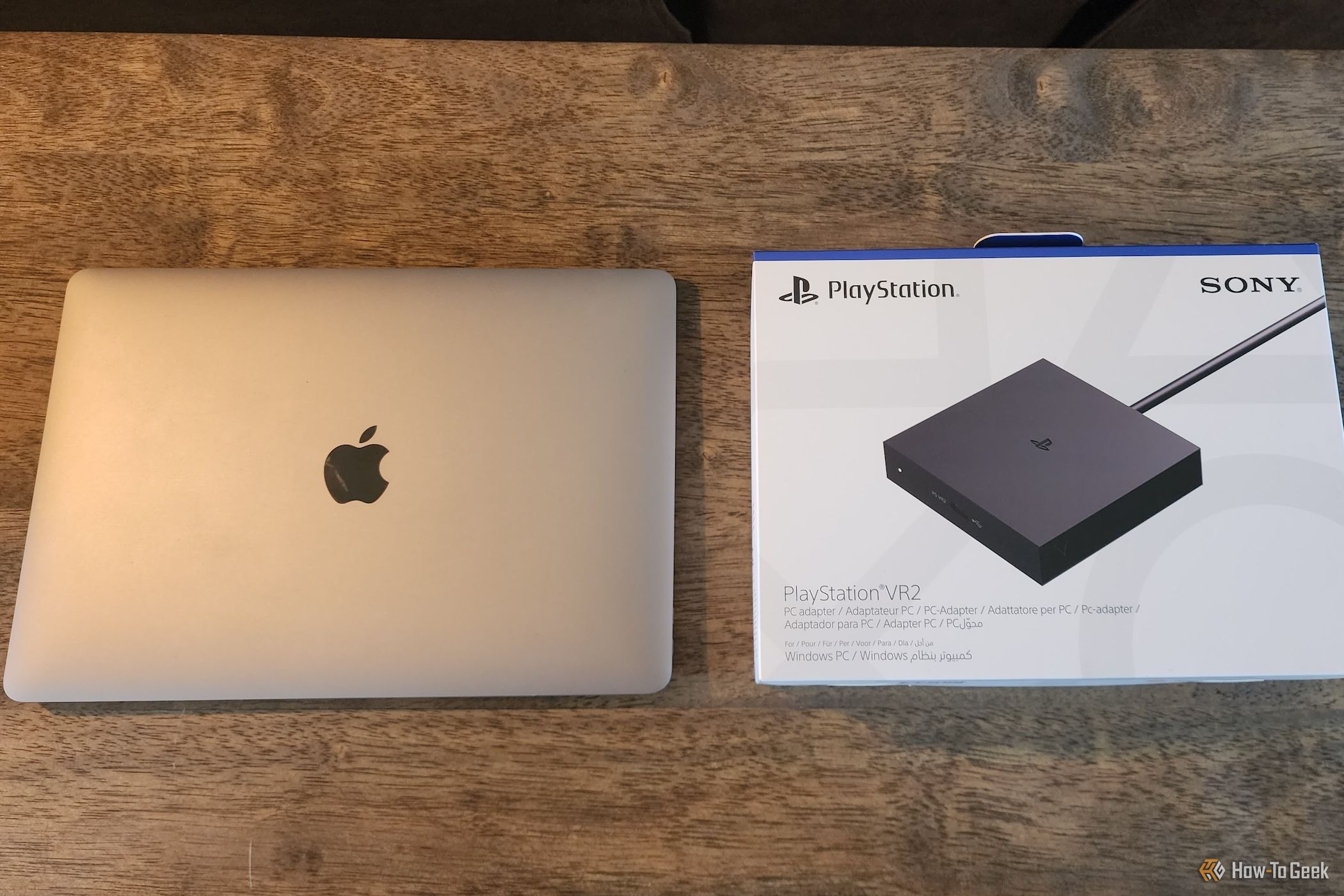 PlayStation VR2 PC adapter box next to a MacBook Air 13.