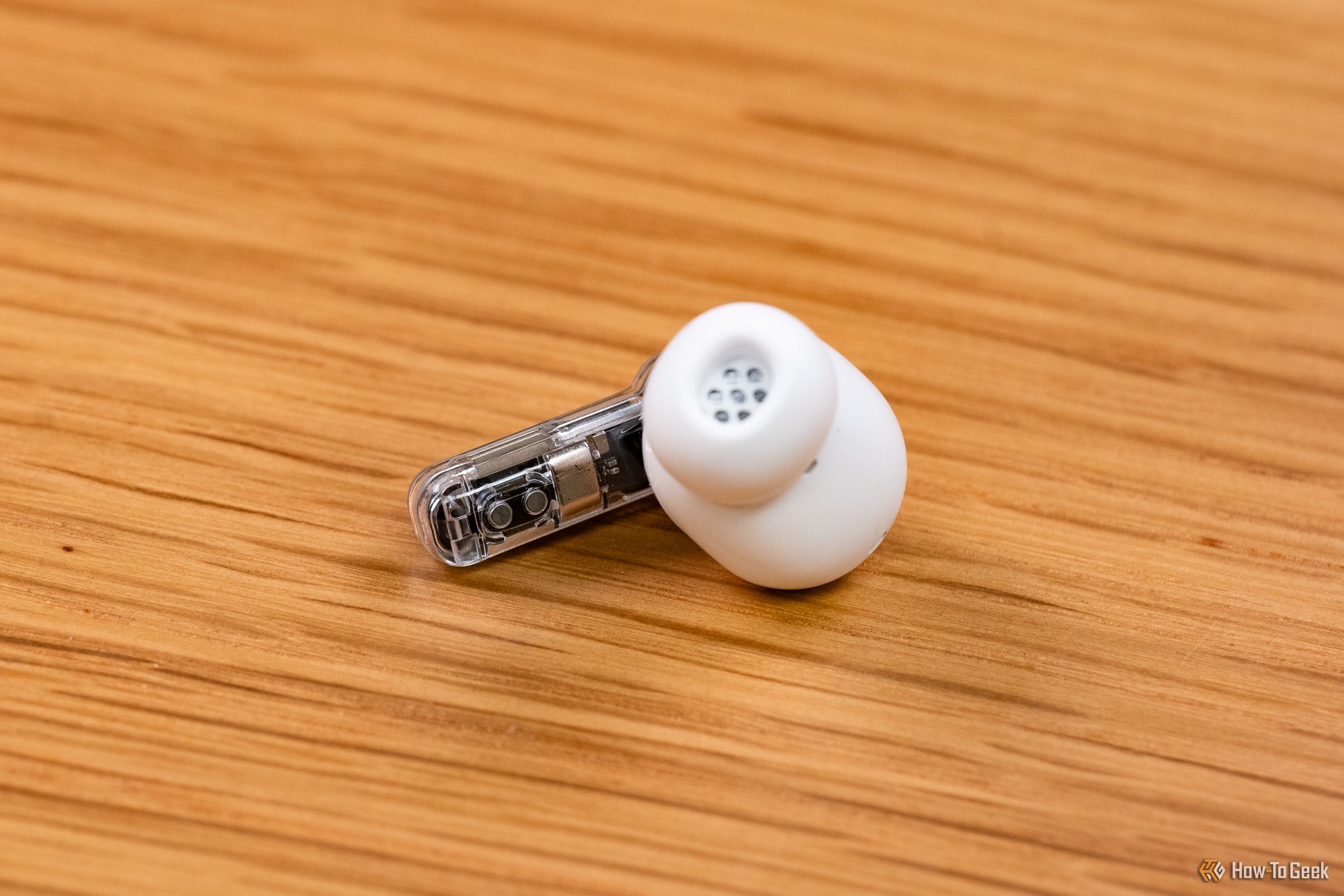 A single Nothing Ear bud on a table