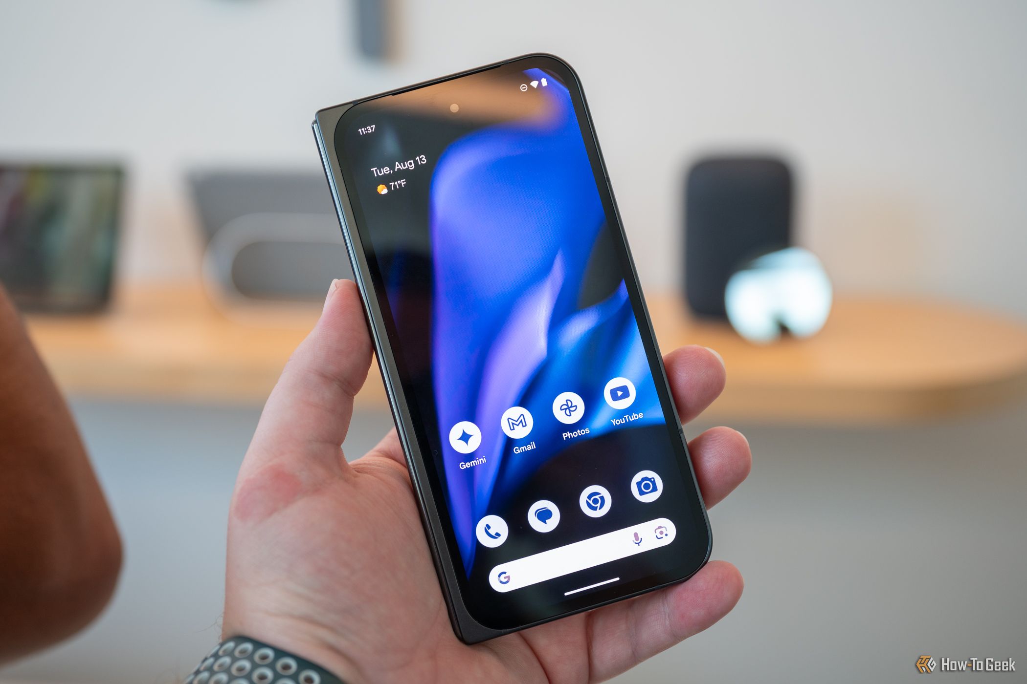 Person holding the Google Pixel 9 Pro Fold showing the cover display