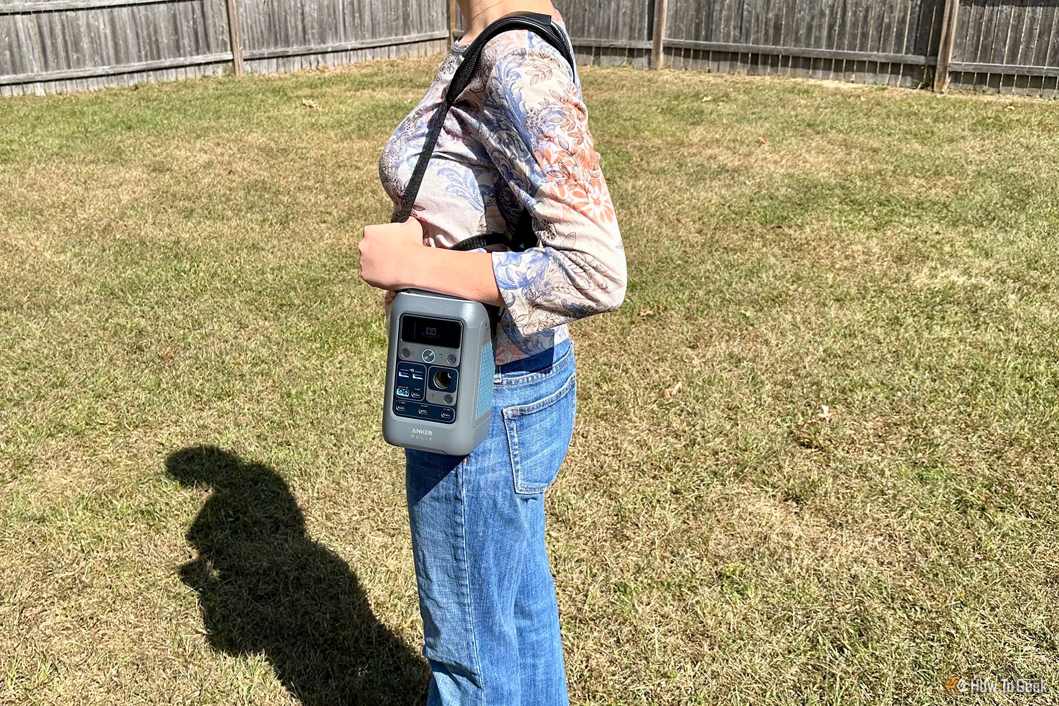 Woman using Anker Adjustable Strap to hold Anker SOLIX C300 DC outdoors