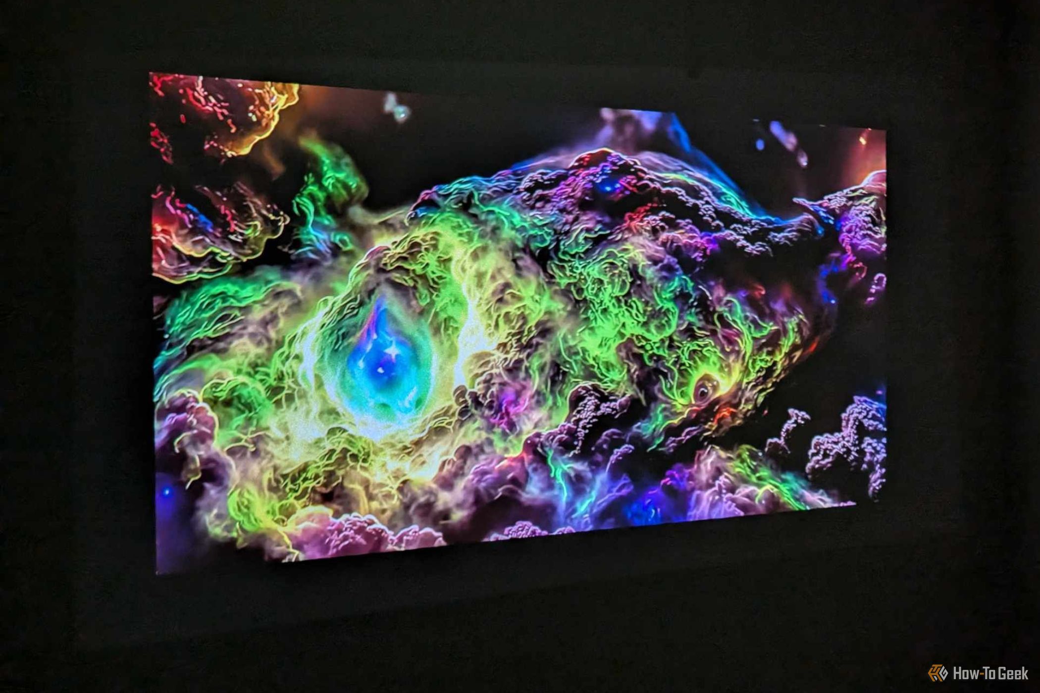 BenQ GV50 ceiling projector casting colorful ambient image against the wall.