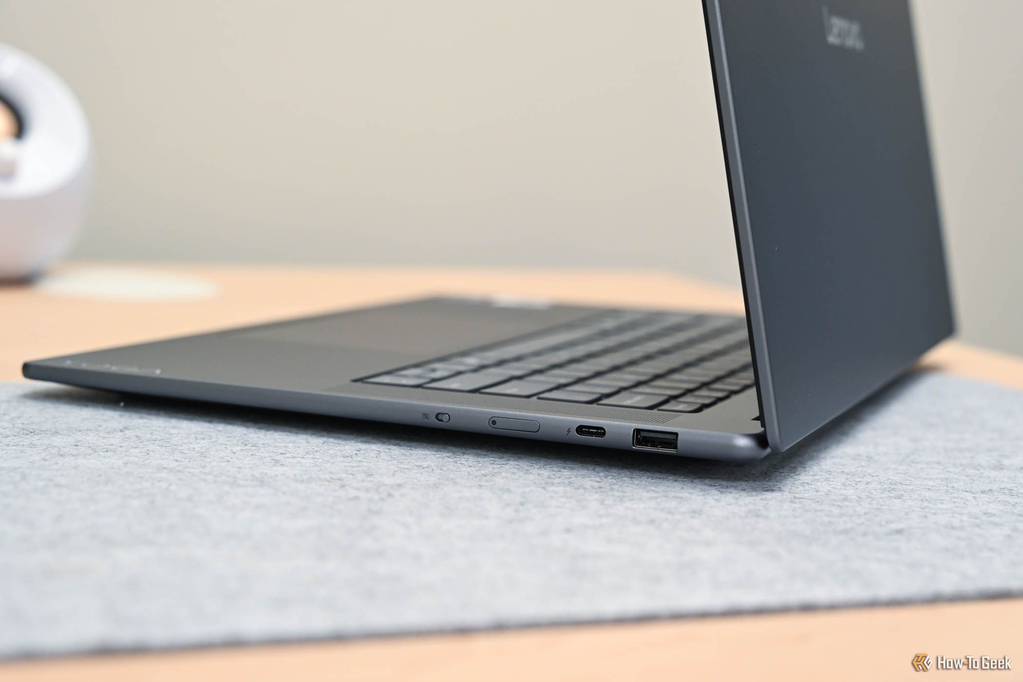 Thunderbolt 4, USB Type A, power button, and webcam mute button the side of the Lenovo Yoga Slim 7i Aura Edition.