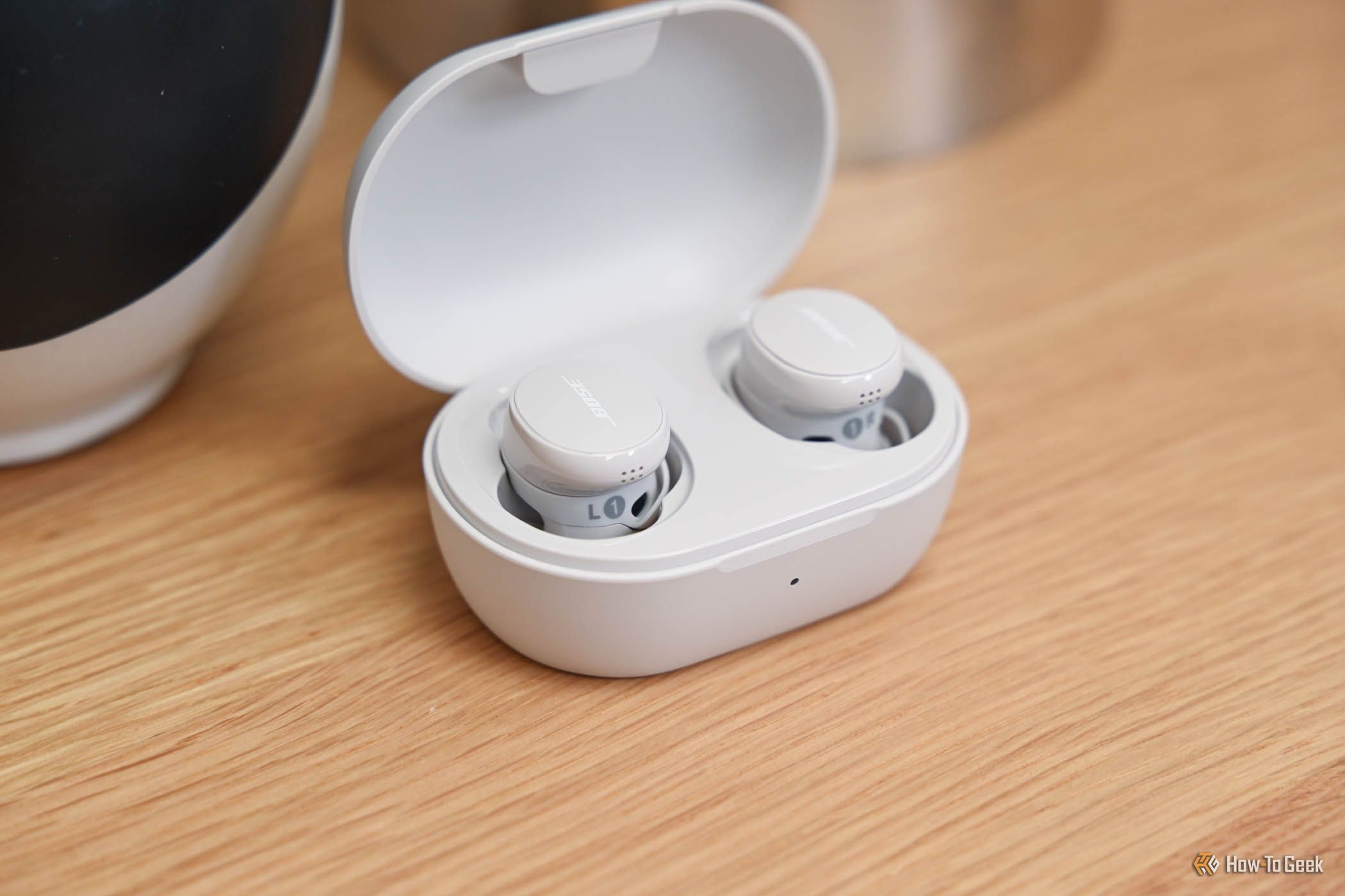 The Bose QuietComfort Earbuds in their charging case.