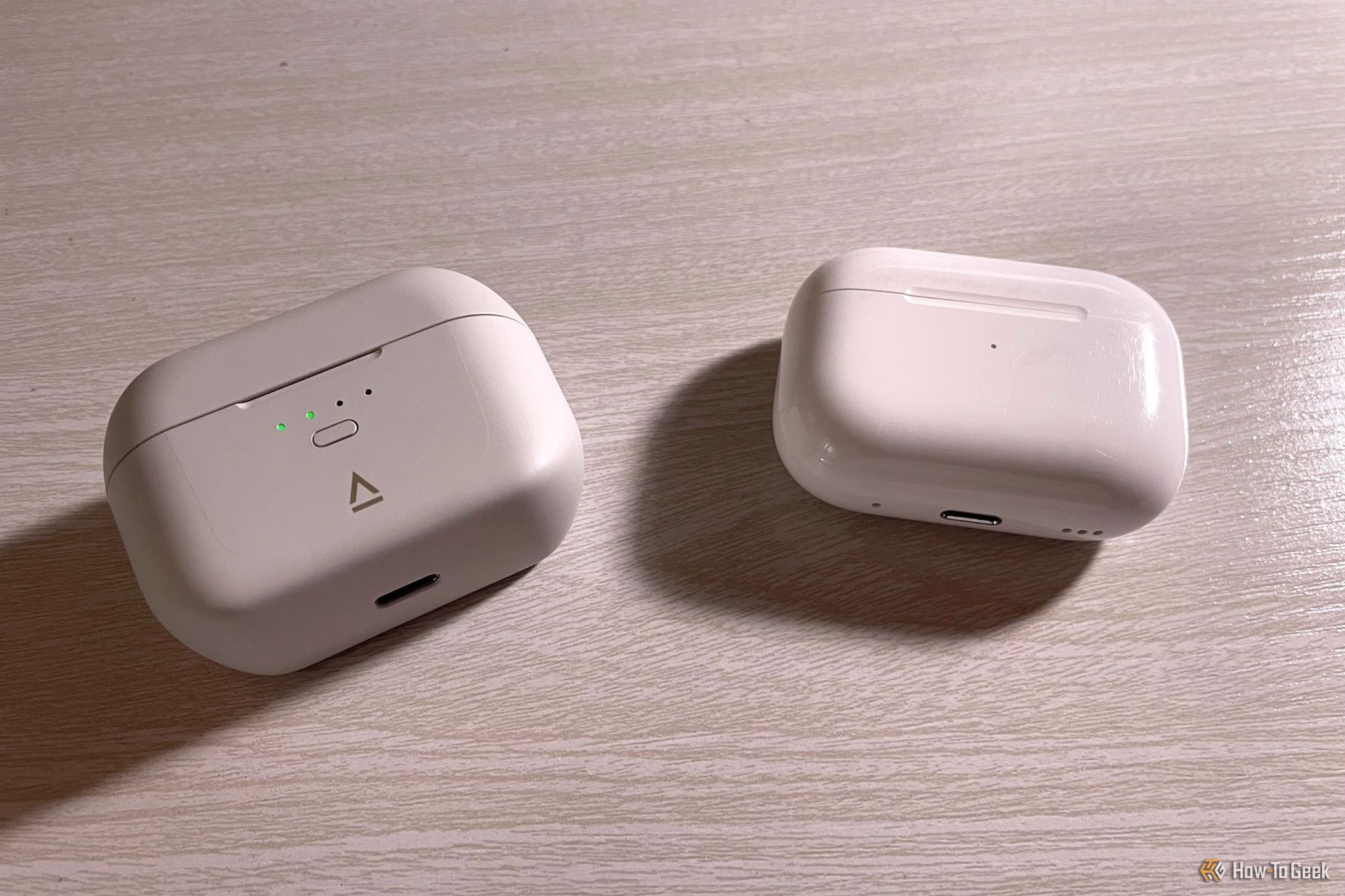 The Creative Zen Air SXFI charging case next to an AirPods charging case.