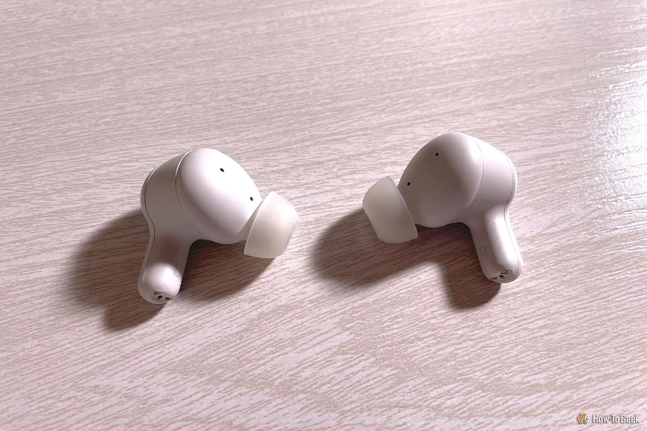 The Creative Zen Air SXFI earbuds on a table.