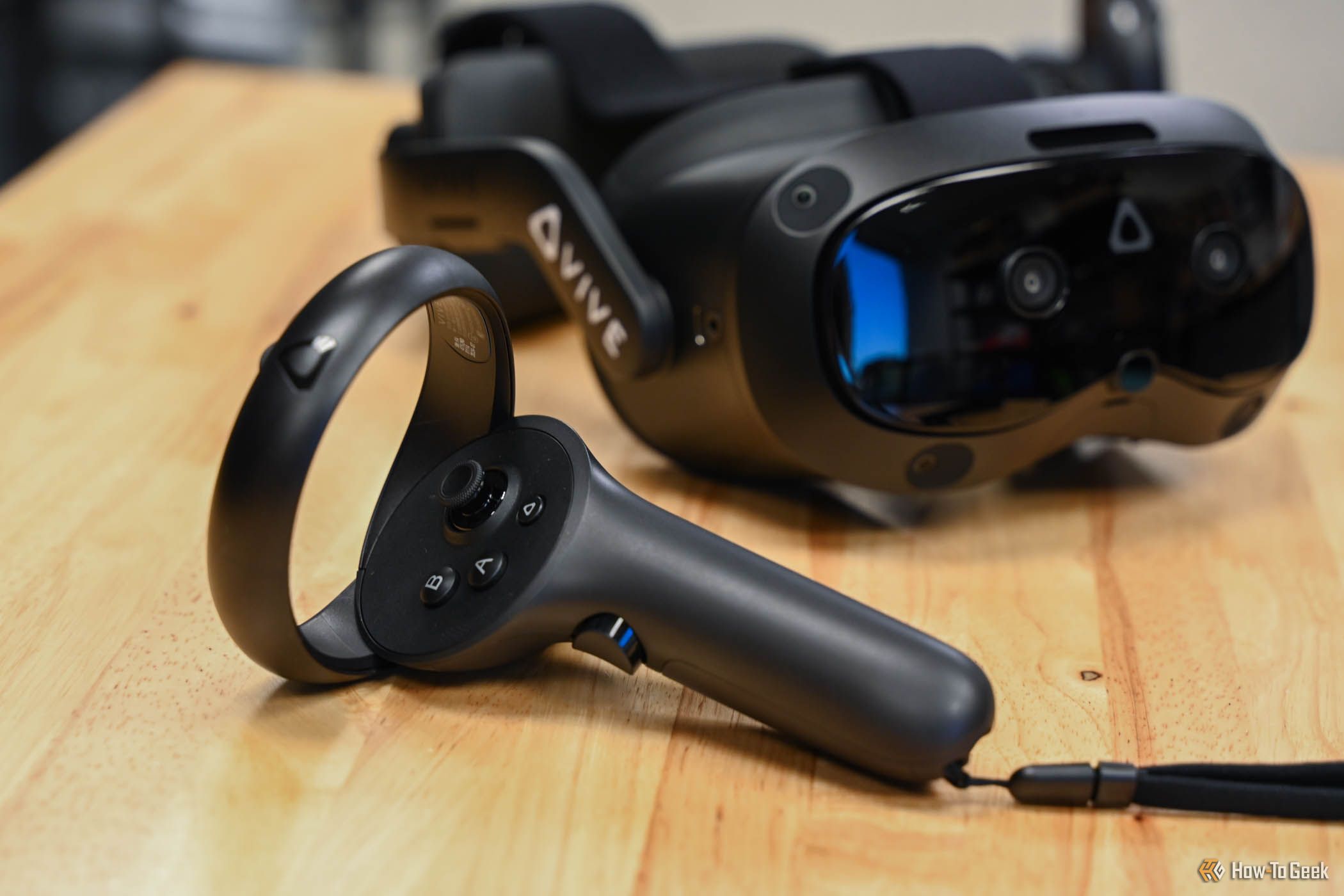 HTC VIVE Focus Vision controller next to the headset.