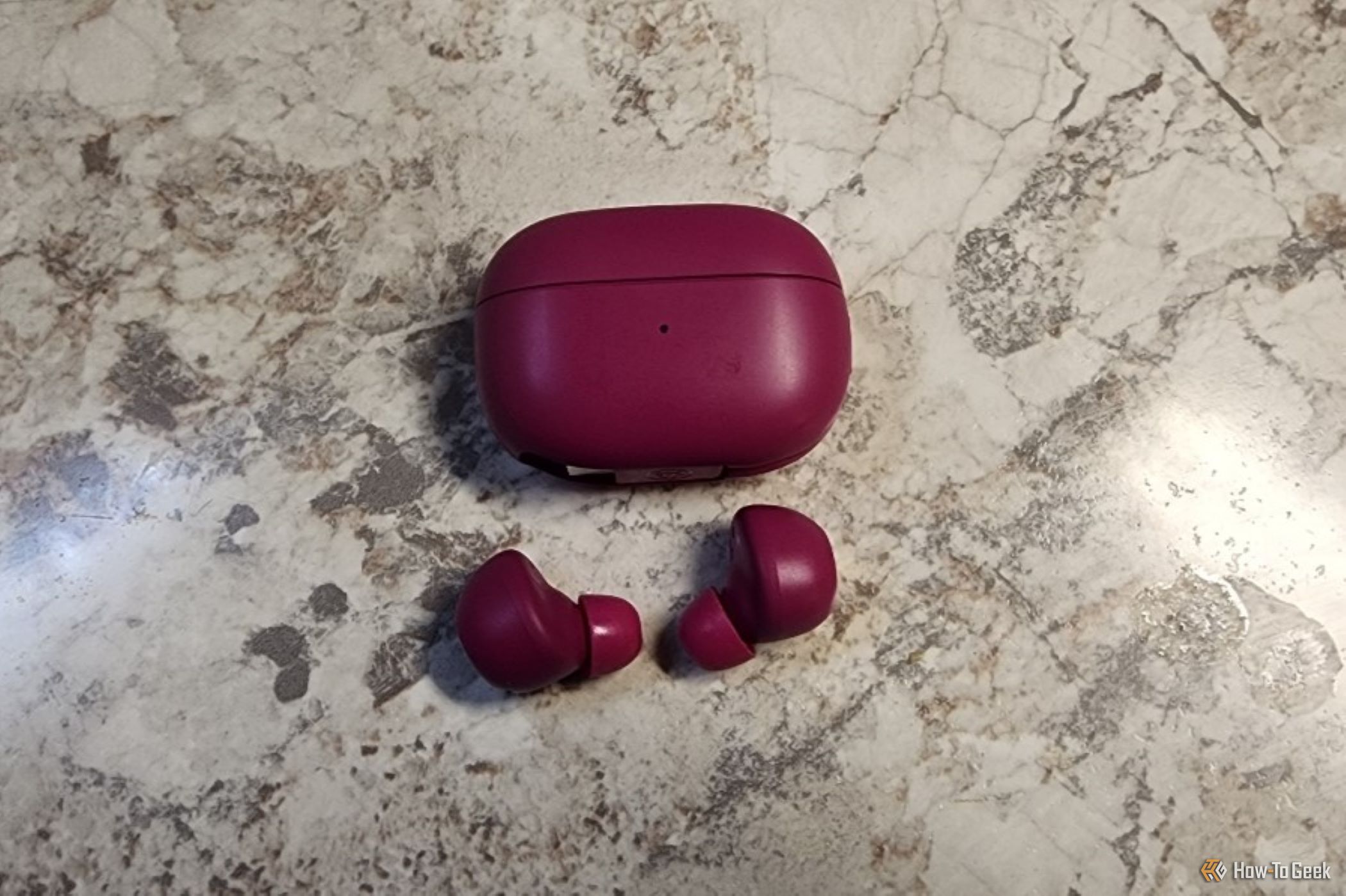 The JLab Go Pop ANC earbuds and case on a counter