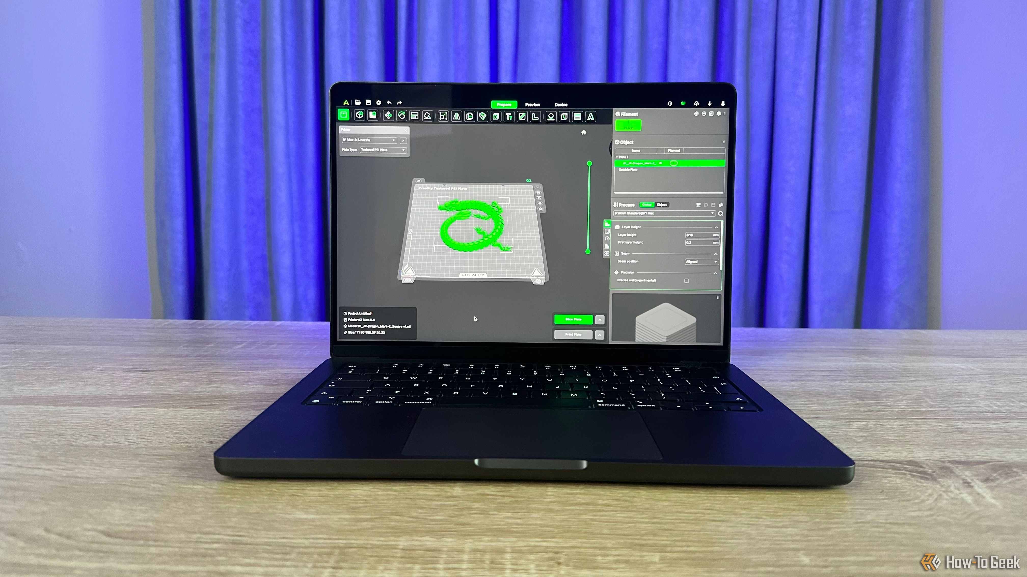 The Apple M4 Pro MacBook Pro on a table showing a 3D printing app on its screen.